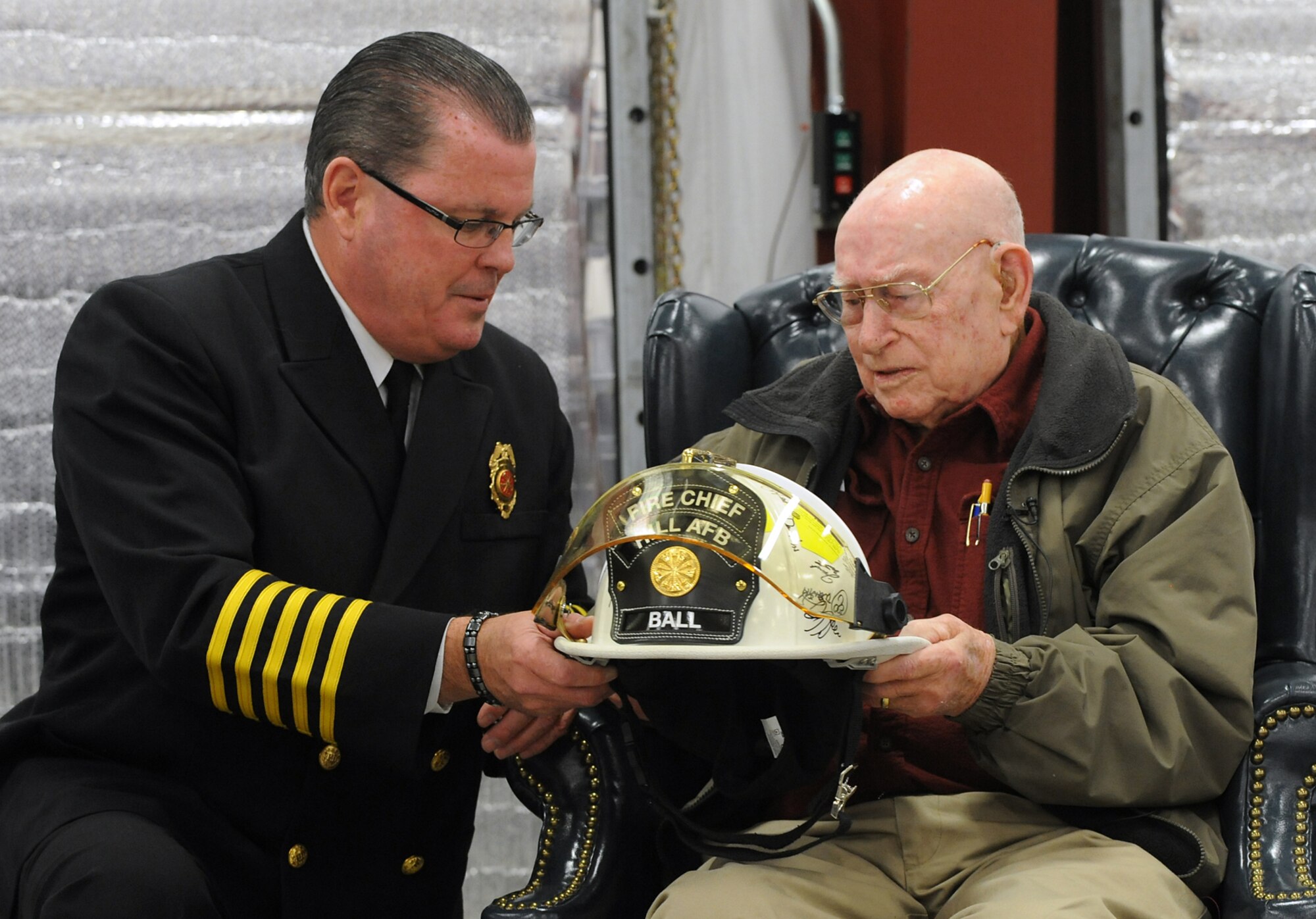 Paul Erickson, Chief of Fire and Emergency Services, presents Shirley Leroy Ball of Kaysville, Utah, with a memento Nov. 13 to recognize him as Hill Air Force Base’s first ever “Honorary Fire Chief.” Ball, a retired Hill firefighter of 31 years, also celebrated his 100th birthday and was honored for his decades of support to the base’s fire department. (U.S. Air Force photo by Alex R. Lloyd/Released)