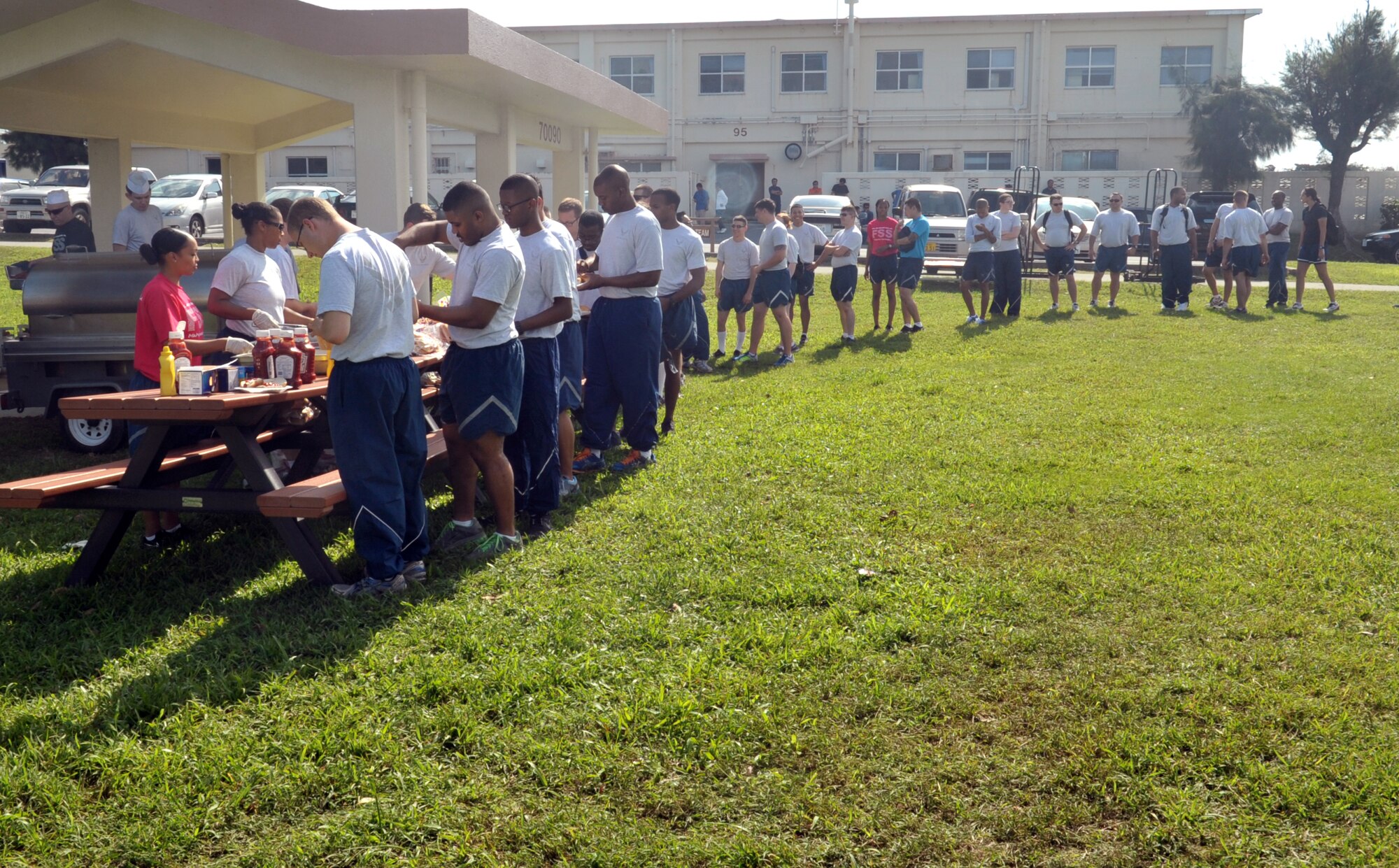 Participants from the 18th Mission Support Group enjoy hot dogs and hamburgers for lunch during the 18th MSG Sports Day at Marek Park on Kadena Air Base, Japan, Nov. 8, 2013. Approximately 800 members from 18th MSG participated in the event. (U.S. Air Force photo by Naoto Anazawa)
