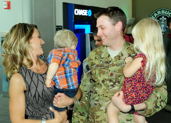 Maj. David, 427th Reconnaissance Squadron, receives a warm welcome home from his wife and two children Nov. 7, 2013, at Sacramento International Airport. The 427th Reconnaissance Squadron organizes, trains, equips and deploys MC-12W aircraft and aircrew in support of combatant commander-directed operational requirements. (U.S. Air Force photo by Airman 1st Class Bobby Cummings/Released)