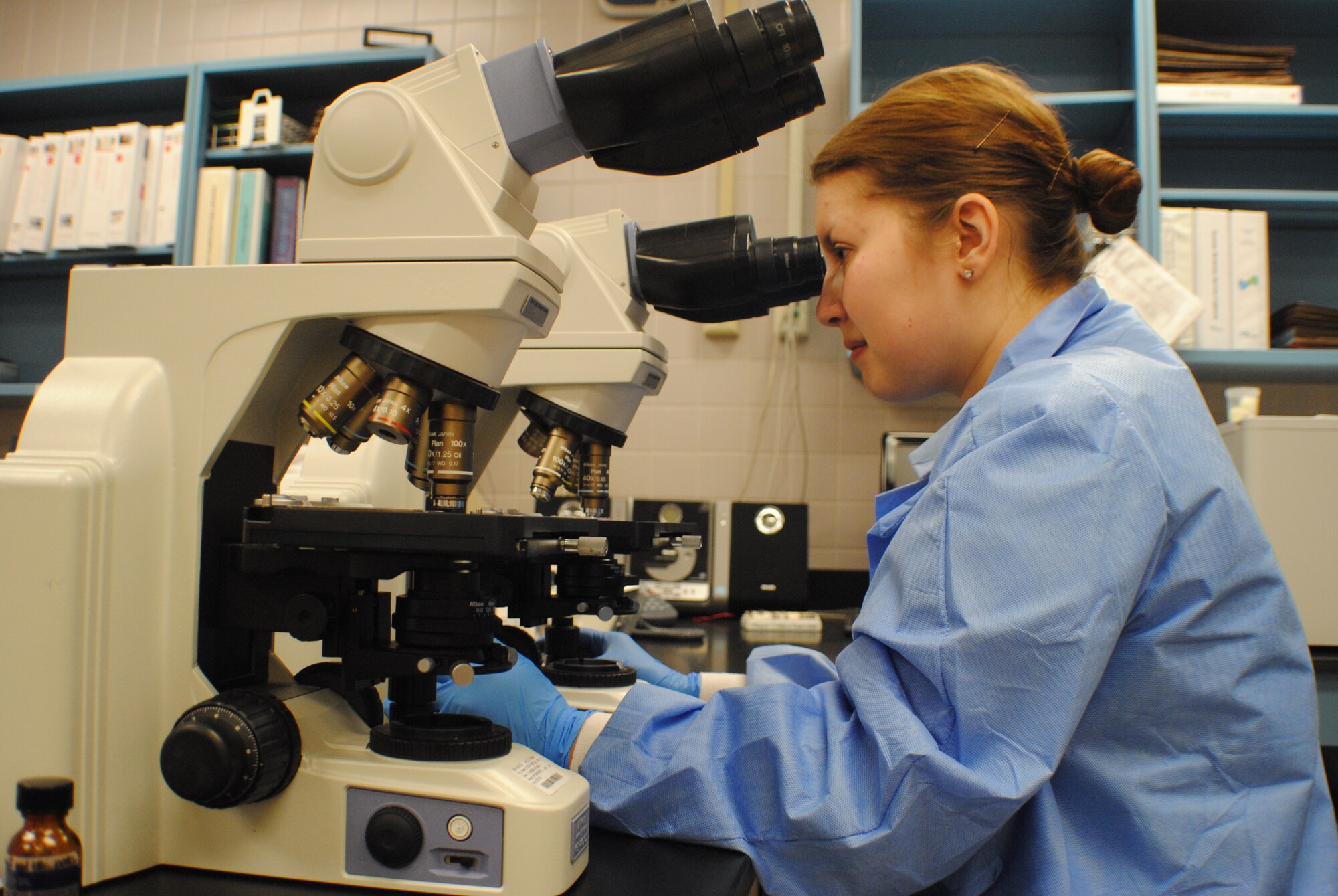 Senior Airman Katherine Herzer, 319th Medical Support Squadron laboratory technician, adjusts the focus on a microscope, Nov. 8, 2013, at the medical laboratory on Grand Forks Air Force Base, N.D. Herzer was named the base’s Warrior of the Week for the second week of November, 2013. The base medical laboratory services are accredited by the College of American Pathologists. (U.S. Air Force photo/Staff Sgt. Luis Loza Gutierrez)
