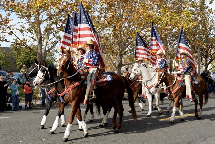 Patriotic horse riders march during the Yuba/Sutter Veterans Day Parade in Marysville, Calif., Nov. 11, 2013. Marysville has hosted the annual parade since 2002. (U.S. Air Force photo by Staff Sgt. Robert M. Trujillo/Released)