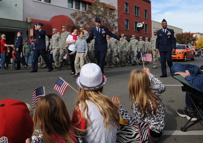 9th Reconnaissance Wing leaders march with members of Team Beale during the Yuba/Sutter Veterans Day Parade in Marysville, Calif., Nov. 11, 2013. Col. Phil Stewart, 9th RW commander, served as the grand marshal of the event. (U.S. Air Force photo by Staff Sgt. Robert M. Trujillo/Released)  