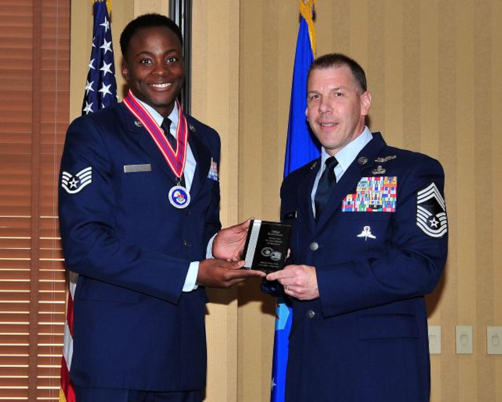 (Left) Staff Sgt. Adam Grant, 12th Air Force (Air Forces Southern) NCOIC of Operations, presents a token of appreciation on behalf of Airman Leadership Class 14A to Chief Master Sgt. David Swan, 563 Rescue Group superintendent, on Davis-Monthan AFB, Ariz., Nov. 7,  2013. (U.S. Air Force Photo by Senior Airman Joshua Slain/Released) 