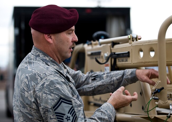 Senior Master Sgt. Robert Bean, 88th Test and Evaluations Squadron superintendent, examines the Guardian Angel Air Deployable Vehicle Nov. 12, 2013, at Nellis Air Force Base, Nev. The purpose of the 88 TES is to maximize HH-60 Pavehawk, HC-130 Hercules, and Guardian Angel Weapon System capability by fielding combat ready solutions to combat search and rescue forces through innovation, test and evaluation, and tactics development in order to perfect lethality, survivability and sustainability of the nation’s forces. (U.S. Air Force photo by Airman 1st Class Jason Couillard)