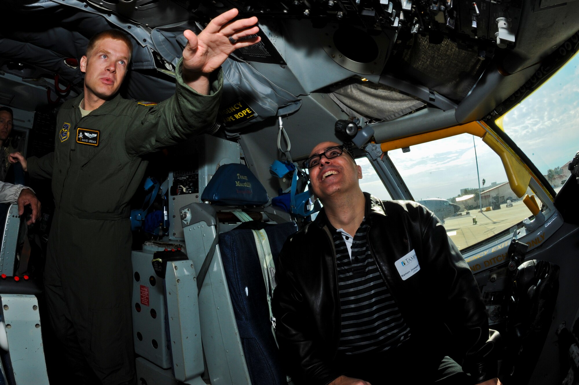 1st Lt. David Urban, a pilot with the 91st Air Refueling Squadron, teaches Ray Sierra, USAA insurance manager, the different switches and toggles in the cabin of a KC-135 Stratotanker during an Operation Partnership event at MacDill Air Force Base, Fla., Nov. 13, 2013. Operation Partnership brought 25 local civic leaders onto MacDill to partner with 25 base members for a day-long base tour and on-the-job experience. (U.S. Air Force photo by Airman 1st Class Ned T. Johnston/Released)