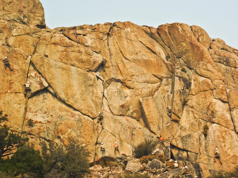 Airmen climb a vertical cliff face while training at the Marine Mountain Warfare Training Center in Bridgeport, Calif.  Approximately three 919th Special Operations Wing firefighters were sent as medical support for Air Force explosive ordnance disposal training in late August. (Courtesy photo)