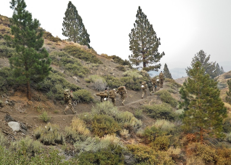 Explosive Ordnance Disposal Airmen walk up a winding mountain road at the Marine Mountain Warfare Training Center in Bridgeport, Calif.  Approximately three 919th Special Operations Wing firefighters were sent as medical support for Air Force EOD training in late August. (Courtesy photo)