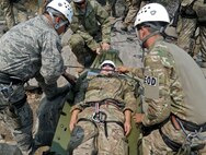 Airmen prepare a rescue stretcher to be lowered down a cliff face at the Marine Mountain Warfare Training Center in Bridgeport, Calif.  Approximately three 919th Special Operations Wing firefighters were sent as medical support for Air Force explosive ordnance disposal training in late August. (Courtesy photo)