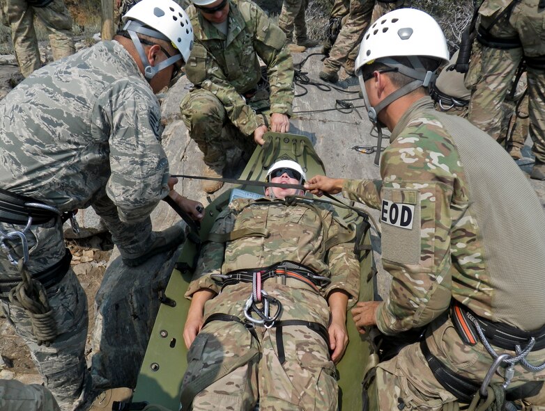 Airmen prepare a rescue stretcher to be lowered down a cliff face at the Marine Mountain Warfare Training Center in Bridgeport, Calif.  Approximately three 919th Special Operations Wing firefighters were sent as medical support for Air Force explosive ordnance disposal training in late August. (Courtesy photo)