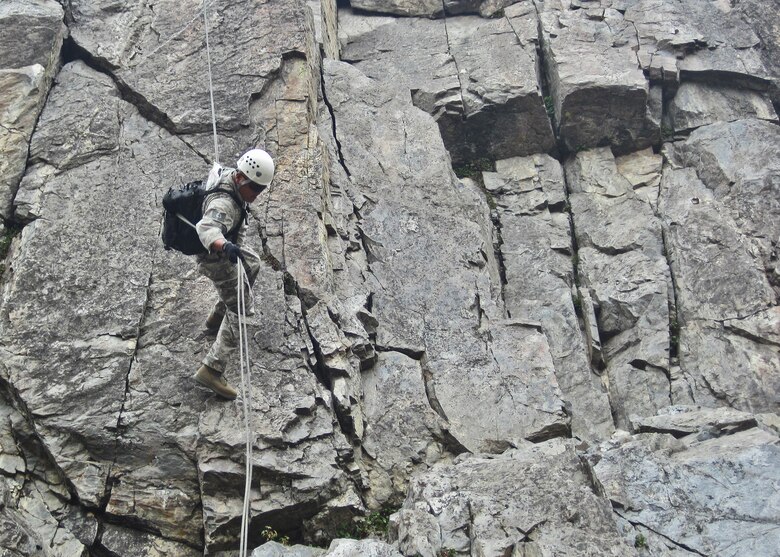 Tech. Sgt. James Acol, a 919th Special Operations Wing firefighter, repels down a cliff face while training at the Marine Mountain Warfare Training Center in Bridgeport, Calif.  Approximately three 919th SOW firefighters were sent as medical support for Air Force explosive ordnance disposal training in late August. (Courtesy photo)