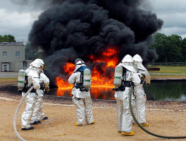 Firefighters wait to attack a JP-8 fire during joint Air Force and Army training at the 2013 Warrior Exercise in late July.  Approximately 14 919th Special Operations Wing firefighters supported the exercise and received their annual fire training while there.  (Courtesy photo)