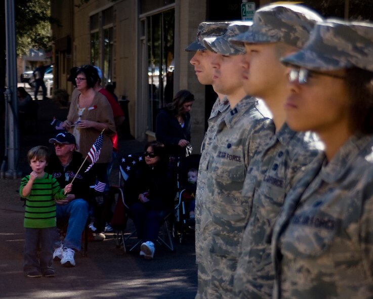 A child looks on as Dyess Airmen stand in formation during the annual Veteran’s Day parade Nov. 9, 2013, in downtown Abilene, Texas. Citizens of Abilene and the surrounding communities lined the streets of the downtown area to show their appreciation for military members and veterans. (U.S. Air Force photo by Senior Airman Peter Thompson/Released)