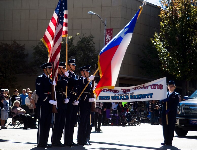 Airmen from the Dyess Honor Guard present the American and Texas flags during the annual Veteran’s Day parade Nov. 9, 2013, in downtown Abilene, Texas. Seven months before the Treaty of Versailles was signed, fighting in World War I ceased when President Woodrow Wilson signed an armistice, or temporary cessation of hostilities, between the Allied nations and Germany, going into effect on the eleventh hour of the eleventh day of the eleventh month. (U.S. Air Force photo by Senior Airman Peter Thompson/Released)