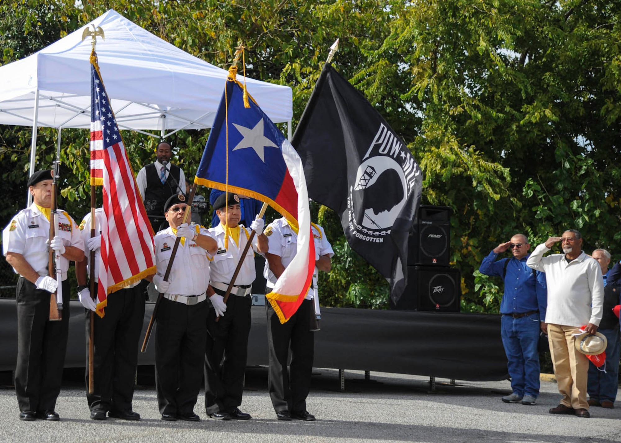 Veterans salute as the Veterans of Foreign Wars Post No. 76 honor guard presents the colors Nov. 8 at the 16th annual American GI Forum Veterans Stand Down. The event provided homeless veterans with medical and dental services, food, winter clothing, flu shots, and haircuts, as well as a variety of other services. (U.S. Air Force photo/Staff Sgt. Kevin Iinuma)