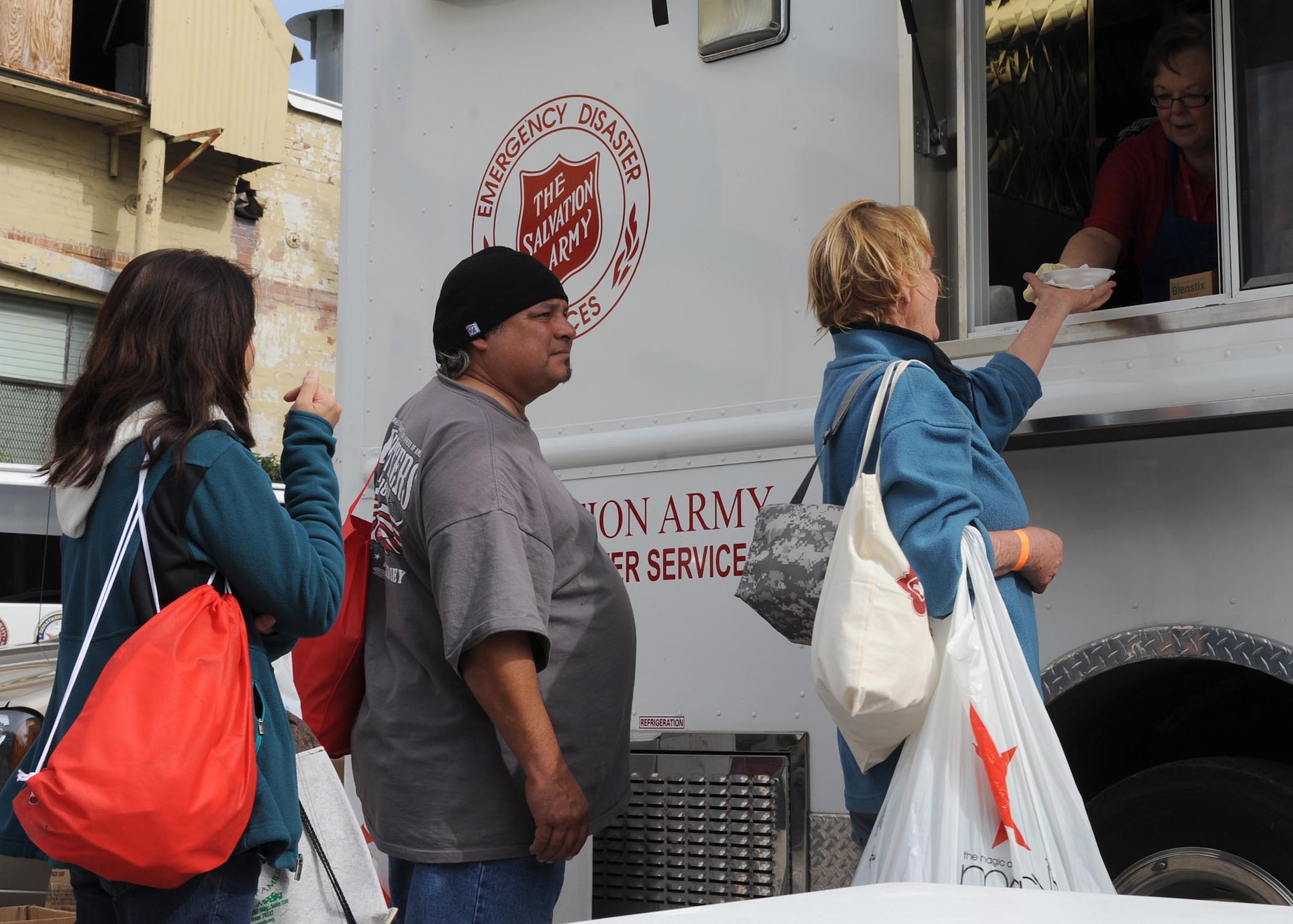 Volunteers with the Salvation Army use an emergency disaster relief food truck to provide hot food to homeless veterans during the American GI Forum Veterans Stand Down Nov. 8 in downtown San Antonio. The Salvation Army was one of several organizations partnering to provide basic necessities in an effort to bring stability to the lives of needy veterans. (U.S. Air Force photo/Staff Sgt. Christopher Carwile)