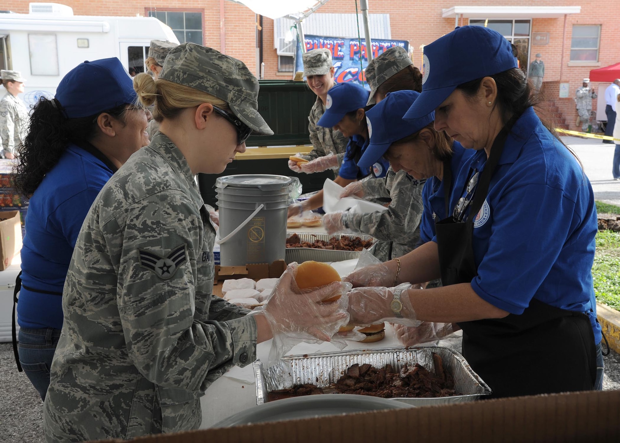 Airmen from the 59th Medical Wing and the San Antonio Military Medical Center work alongside National Veterans Outreach Program volunteers to put together sandwiches during the Nov. 8 American GI Forum Veterans Stand Down. The annual event helps provide homeless veterans with basic necessities like food and clothing, as well as free access to health services and other benefits. (U.S. Air Force photo/Staff Sgt. Christopher Carwile)