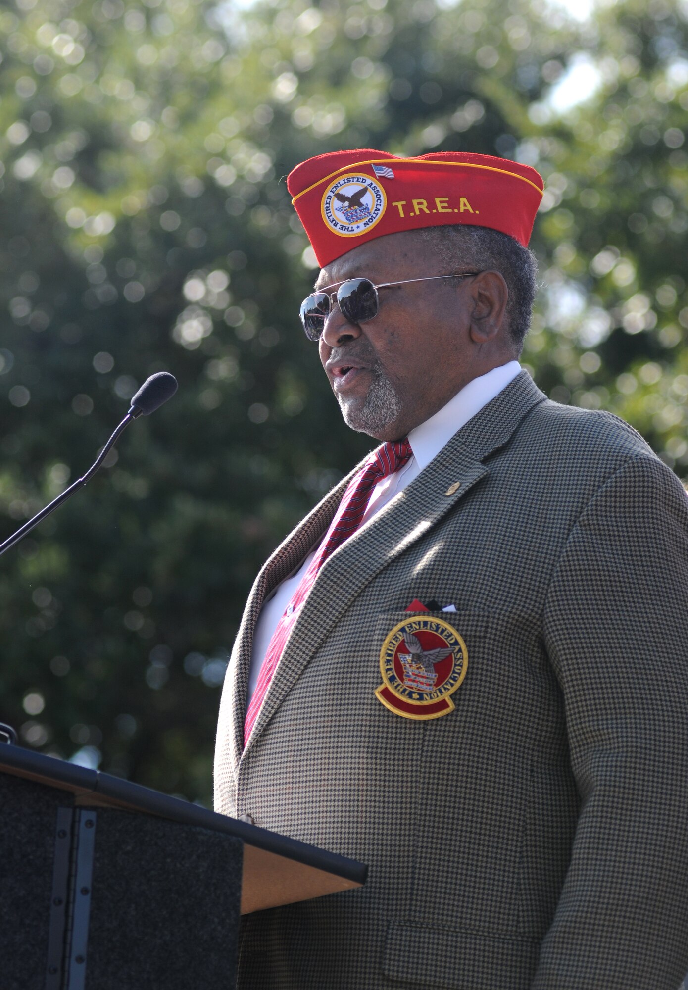 Retired Chief Master Sgt. Chris Moore, sings the National Anthem, as Keesler Airmen render a salute during the 13th Annual Gulf Coast Veteran’s Day Parade in front of City Hall Nov. 9, 2013, Biloxi, Miss.    Keesler’s Wing leadership, Honor Guard, and Airmen, who carried the 50 State Flags, participated in the event. (U.S. Air Force photo by Kemberly Groue)