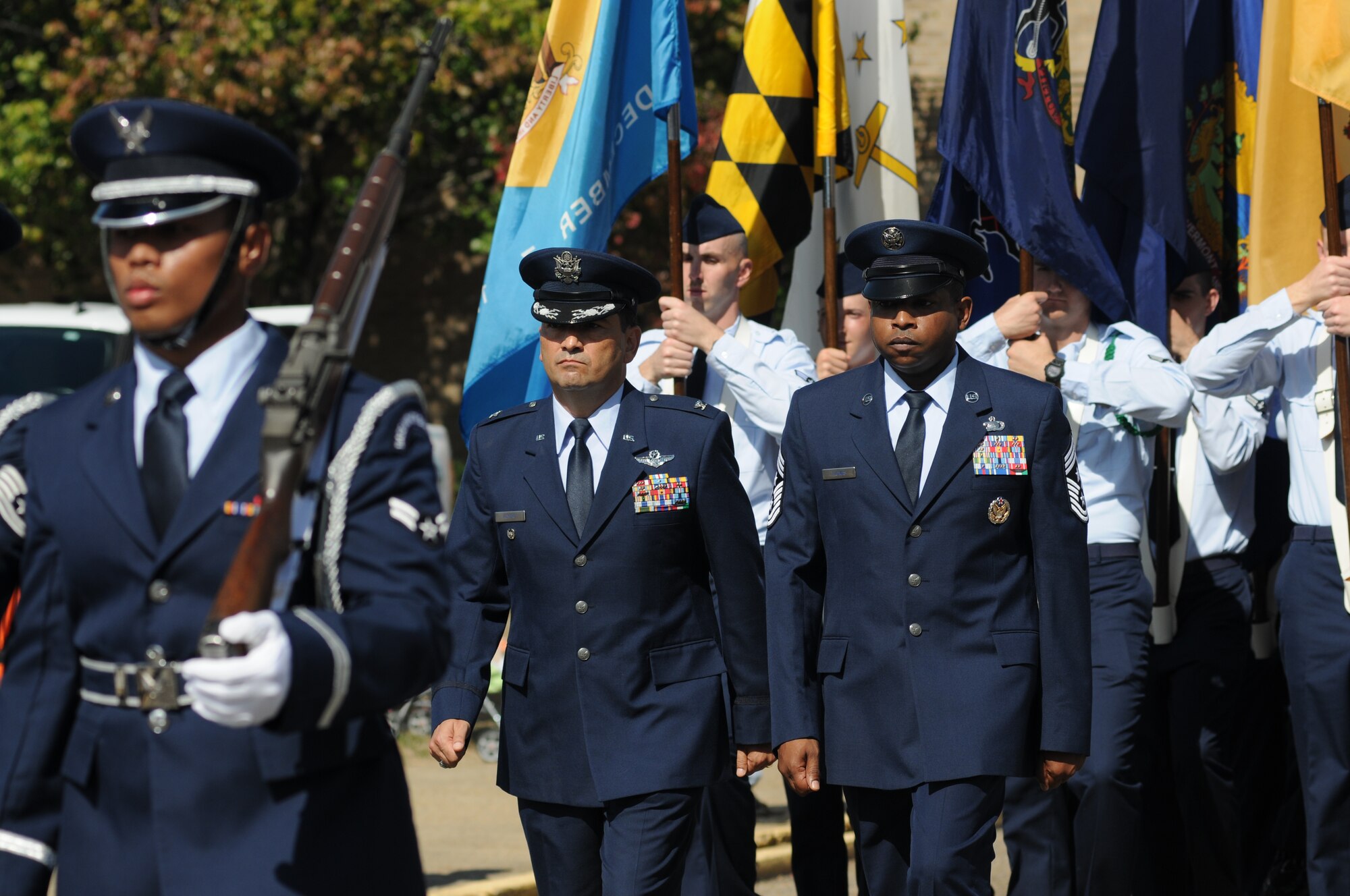 Col. René Romero, 81st Training Wing vice commander and Chief Master Sgt. Farrell Thomas, 81st TRW command chief, march in the 13th Annual Gulf Coast Veterans Day Parade along with the Keesler Honor Guard and Airmen who carried the 50 State Flags Nov. 9, 2013, Biloxi, Miss. Technical training squadron flights also participated in the event. (U.S. Air Force photo by Kemberly Groue)