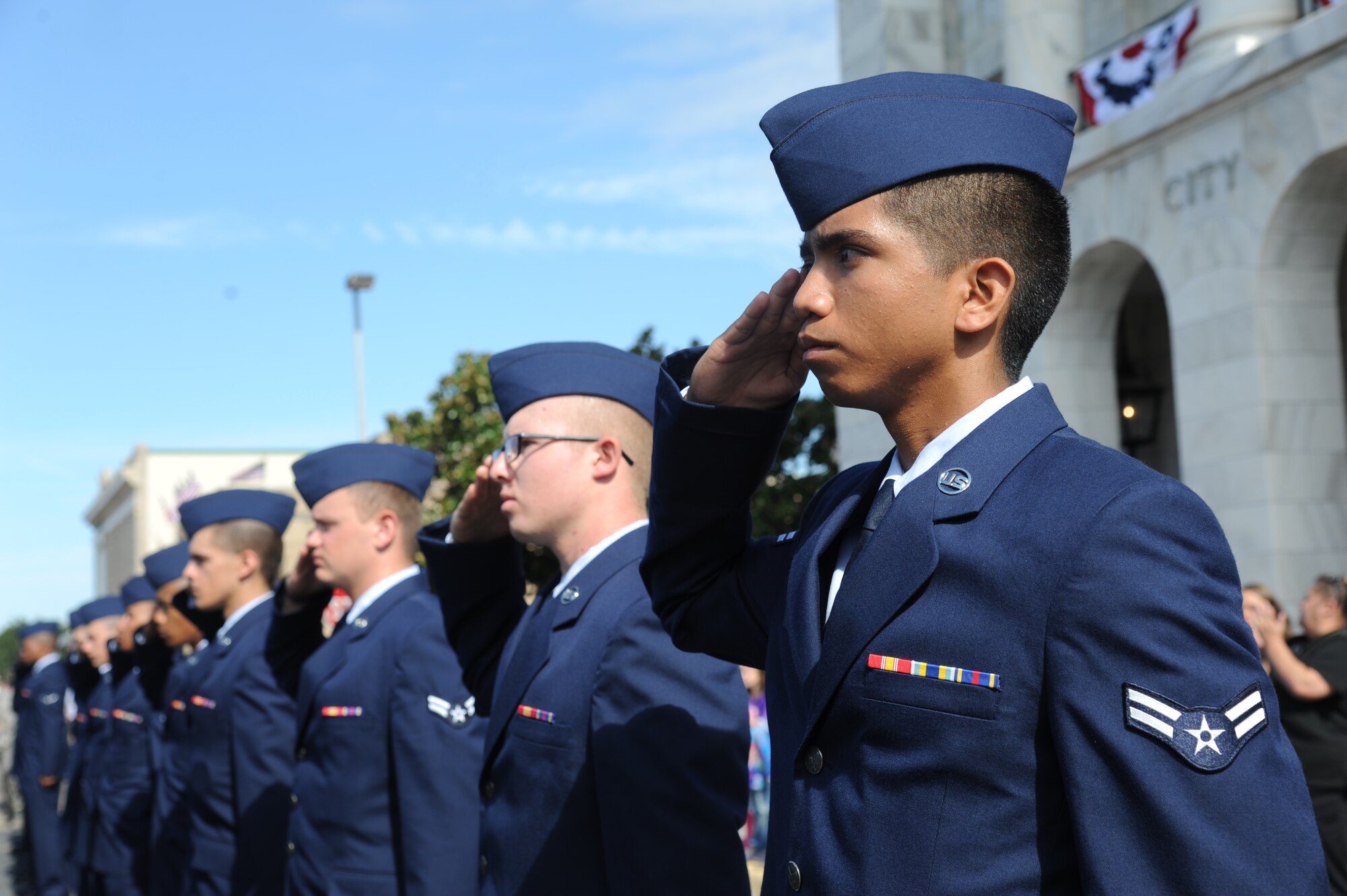 Airman 1st Class Dustin Dalero, 336th Training Squadron, renders a salute along with his flight as the National Anthem is sung during the 13th Annual Gulf Coast Veterans Day Parade in front of City Hall Nov. 9, 2013, Biloxi, Miss. Keesler’s Wing leadership, Honor Guard, and Airmen, who carried the 50 State Flags, participated in the event. (U.S. Air Force photo by Kemberly Groue)