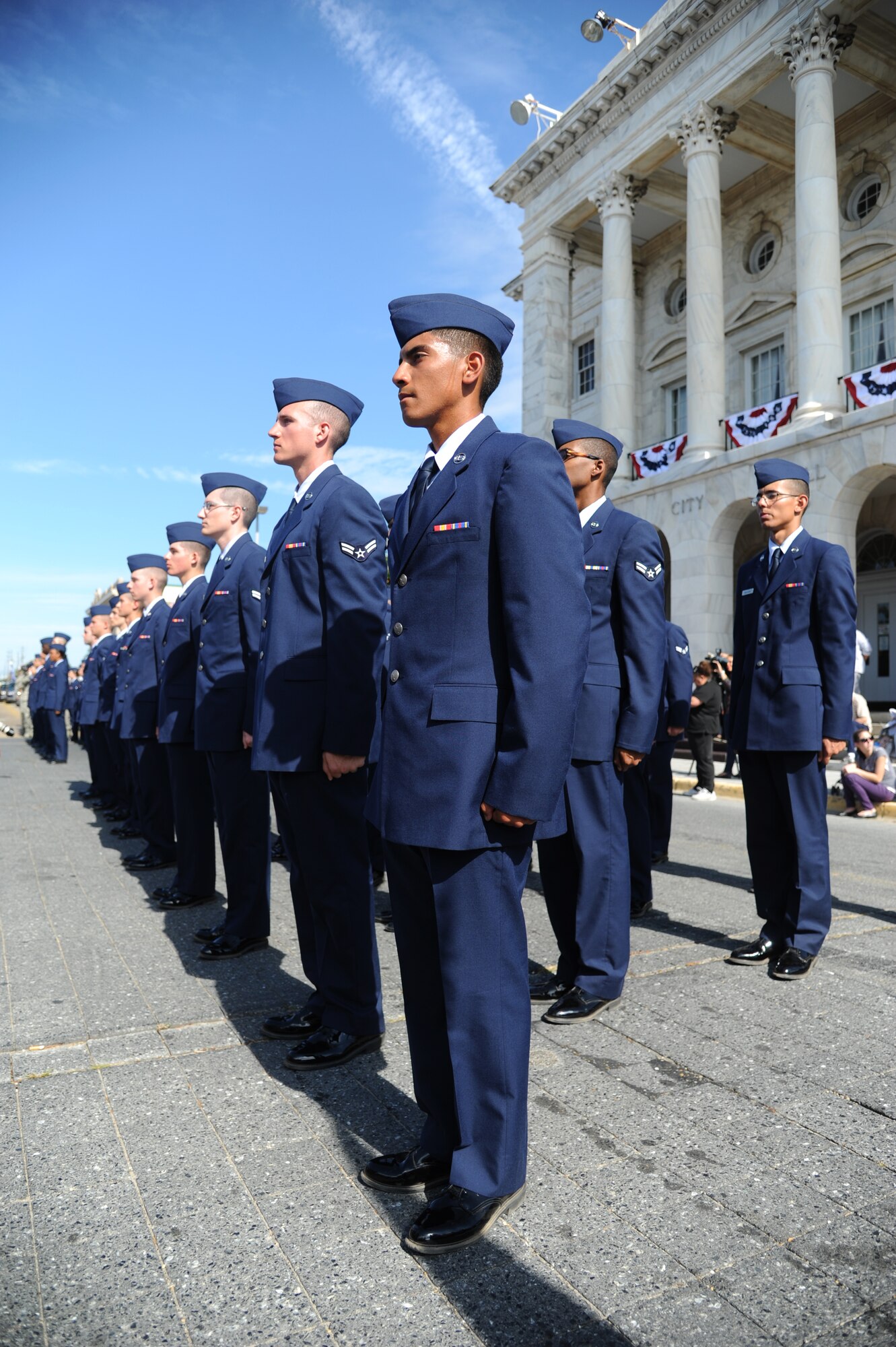 Members of the 336th Training Squadron stand at attention while the Pledge of Allegiance is recited by audience members during the 13th Annual Gulf Coast Veterans Day Parade in front of City Hall Nov. 9, 2013, Biloxi, Miss.  Keesler wing leadership, Honor Guard, and Airmen, who carried the 50 State Flags, participated in the event. (U.S. Air Force photo by Kemberly Groue)
