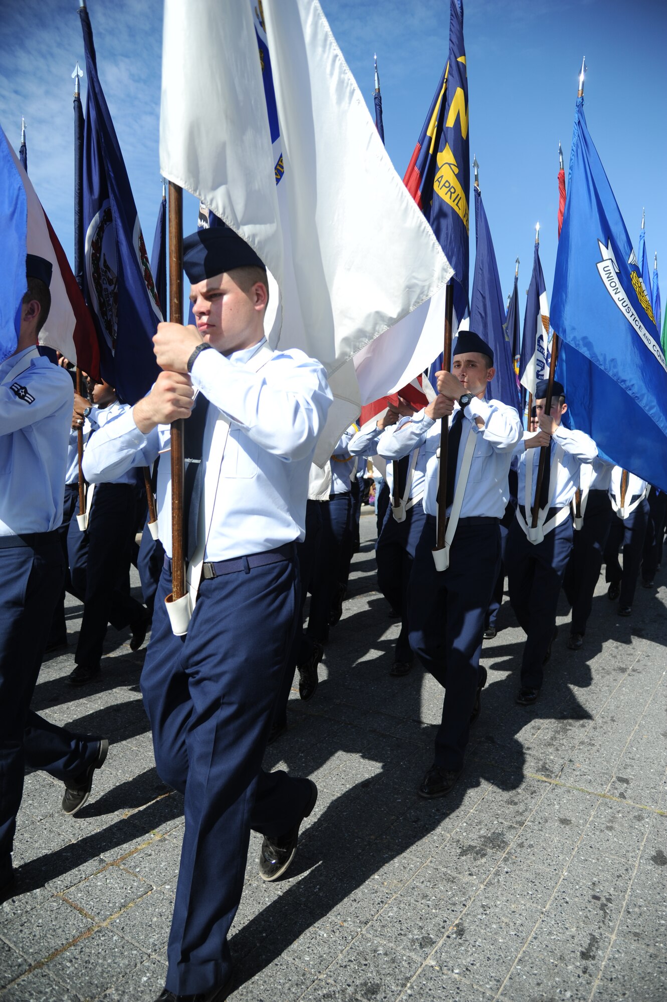 Keesler Airmen carry the 50 State Flags during the 13th Annual Gulf Coast Veterans Day Parade in front of City Hall Nov. 9, 2013, Biloxi, Miss.  Keesler wing leadership and Honor Guard also participated in the event. (U.S. Air Force photo by Kemberly Groue)