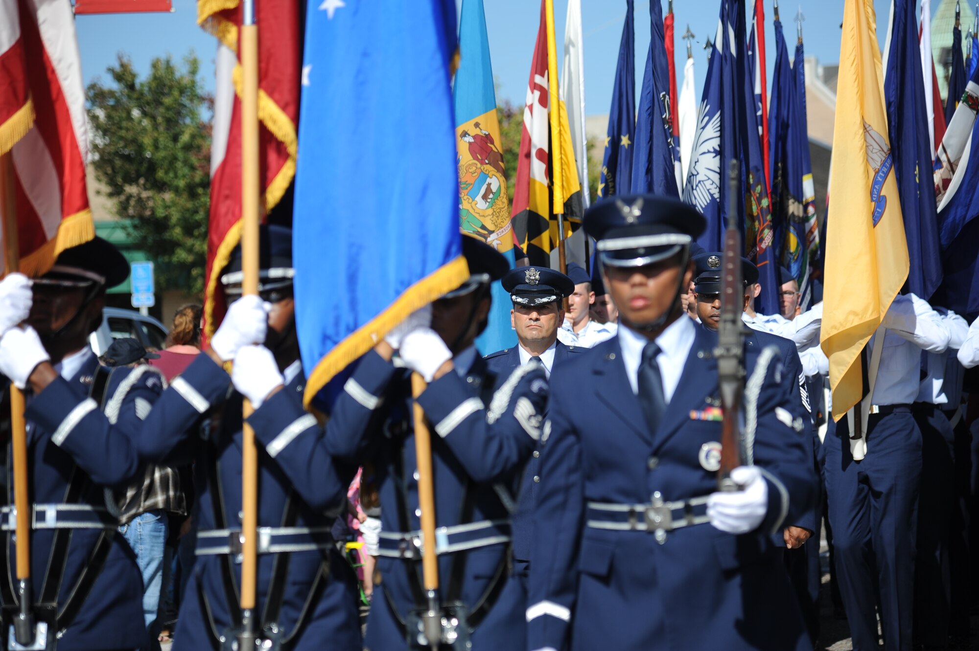 Col. René Romero, 81st Training Wing vice commander and Chief Master Sgt. Farrell Thomas, 81st TRW command chief, march in the 13th Annual Gulf Coast Veterans Day Parade along with the Keesler Honor Guard and Airmen carrying the 50 State Flags Nov. 9, 2013, Biloxi, Miss. Technical training squadron flights also participated in the event. (U.S. Air Force photo by Kemberly Groue)