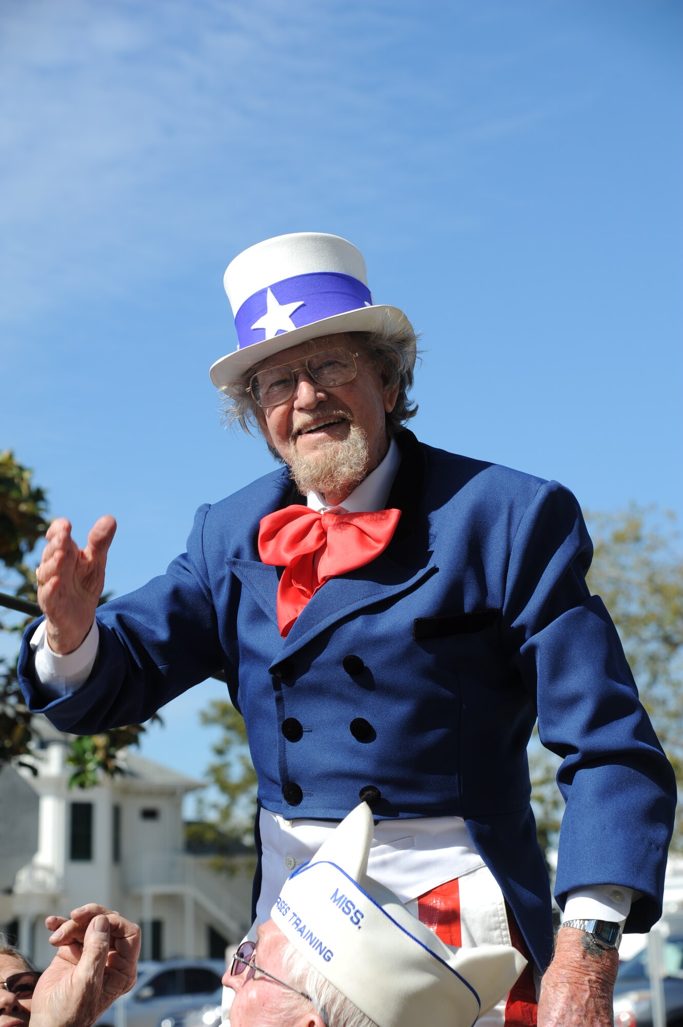 “Uncle Sam” waves to the crowd as he passes City Hall during the 13th Annual Gulf Coast Veterans Day Parade in front of City Hall Nov. 9, 2013, Biloxi, Miss. Keesler’s Wing leadership, Honor Guard, and Airmen, who carried the 50 State Flags, participated in the event. (U.S. Air Force photo by Kemberly Groue)