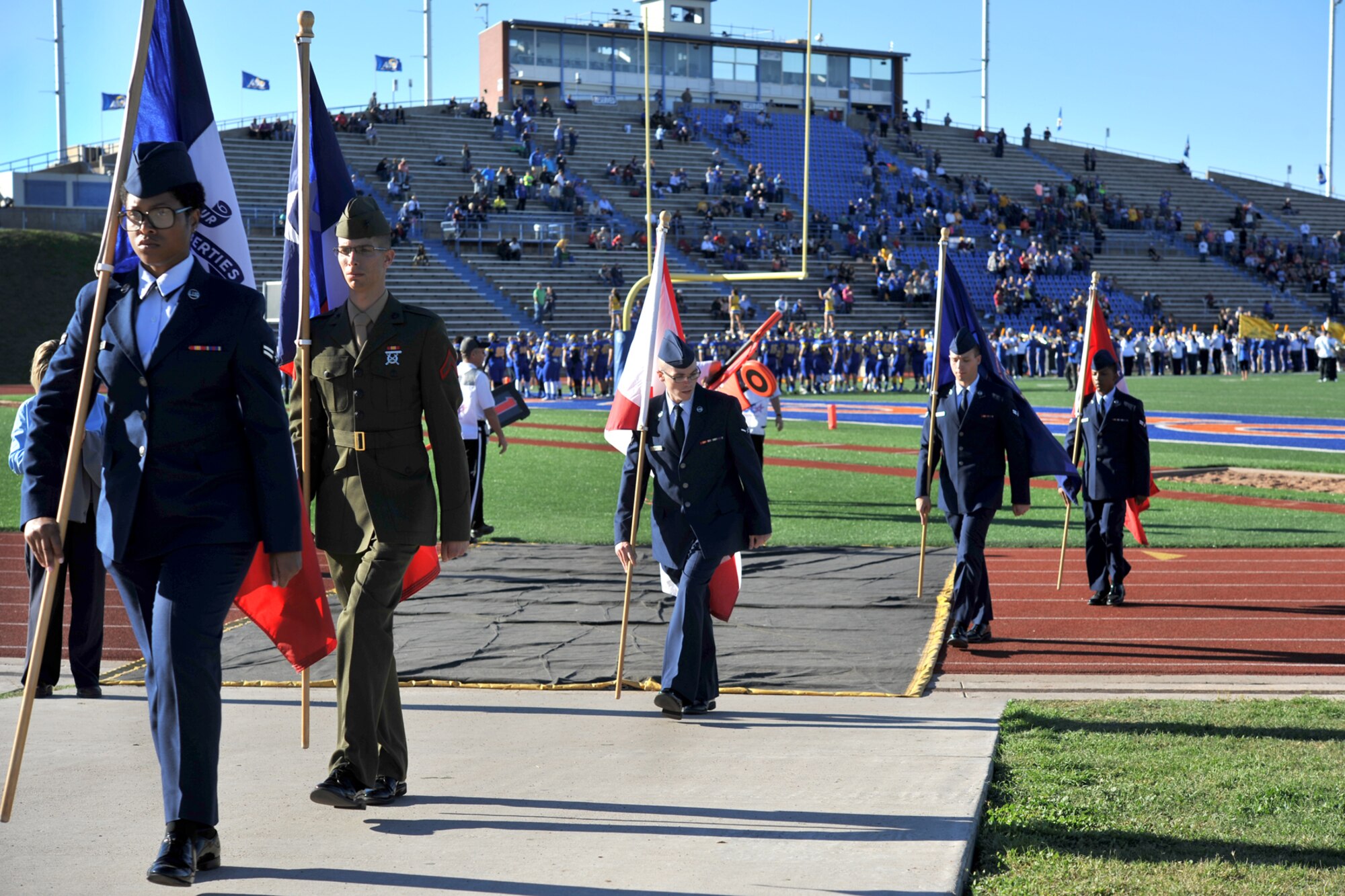 SAN ANGELO, Texas-- Volunteers from Goodfellow Air Force Base march out of the LeGrand Stadium during the Angelo State University Military Appreciation Day football game Nov. 9. Hundreds of service members and veterans came to the football game, to see the ASU Rams face off against Texas A&M- Kingsville, which featured free admission for active duty military members. (U.S. Air Force photo/ Senior Airman Michael Smith)