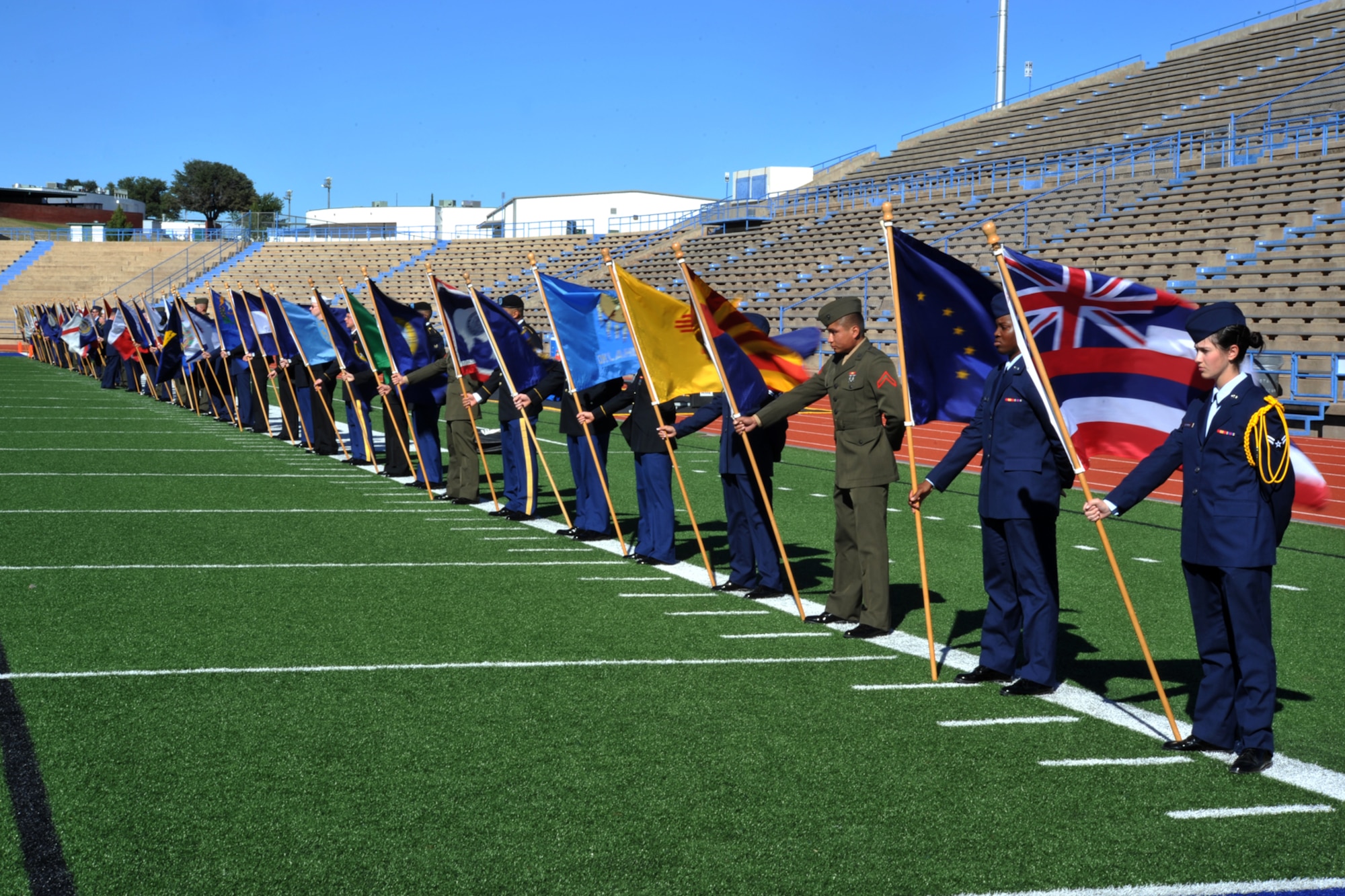 SAN ANGELO, Texas-- Volunteers from Goodfellow Air Force Base hold state flags at the Angelo State University Military Appreciation Day football game Nov. 9 at the LeGrand Stadium. All military personnel and family were invited by ASU to attend the Military Appreciation Day on ASU campus and at the football stadium. (U.S. Air Force photo/ Senior Airman Michael Smith)