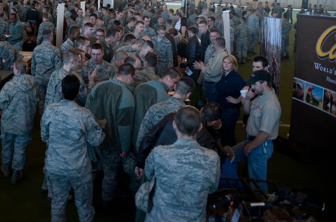 Airmen visit with vendors during the Discover the Hills event in the Pride Hangar during Comprehensive Airman Fitness Day in the Pride Hangar at Ellsworth Air Force Base, S.D., Nov. 4, 2013. The objective for CAF Day was to encourage Airmen to discover opportunities available in the Black Hills with a focus on winter safety.(U.S. Air Force photo by Senior Airman Zachary Hada/Released)