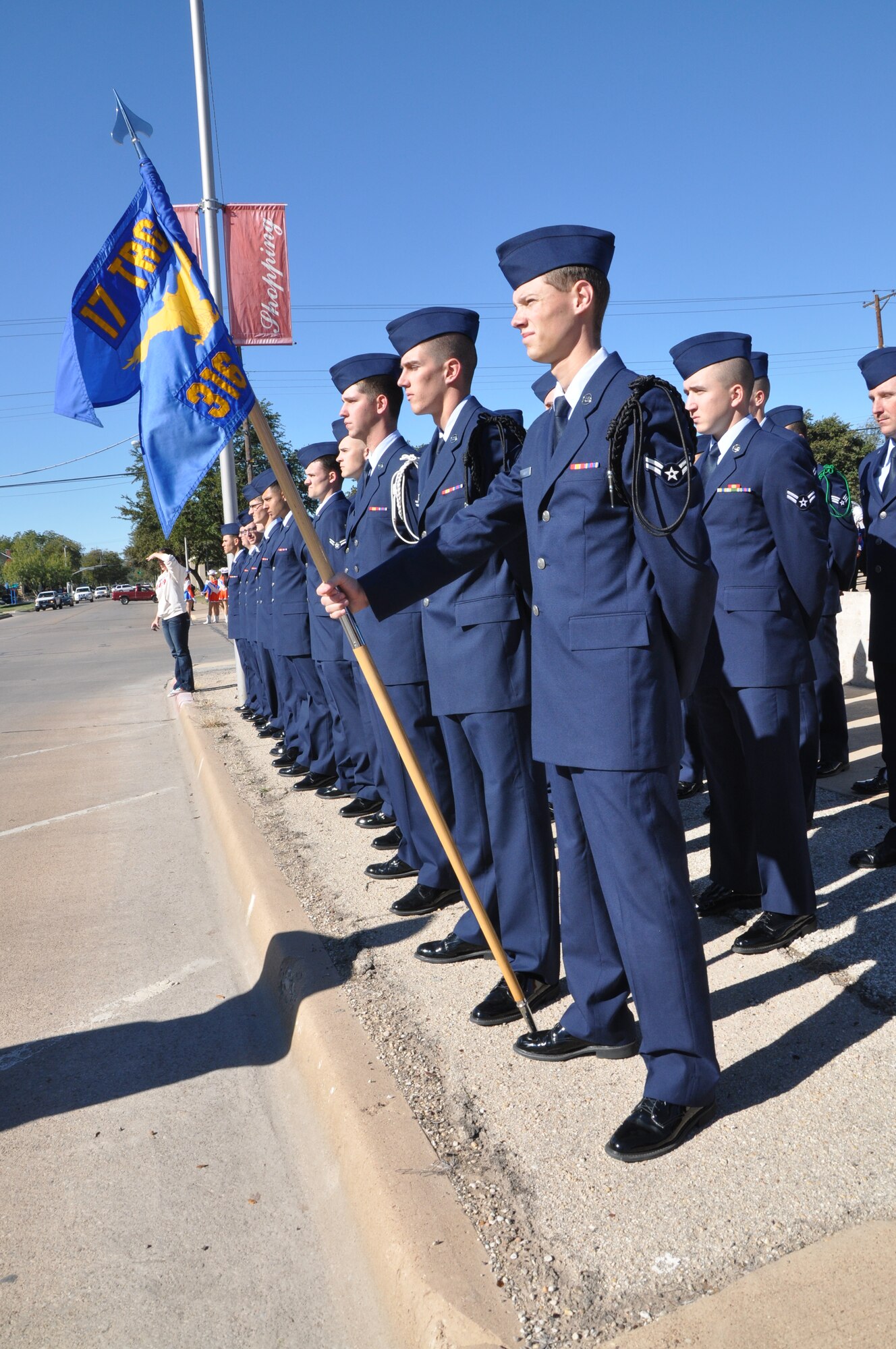 SAN ANGELO, Texas— Airman 1st Class Matthew Karnes, 316th Training Squadron student and guidon bearer, stands with the rest of his flight before the Veteran’s Day Parade Nov. 9 in historic downtown San Angelo. Karnes volunteered for Veteran’s Day Parades for the last six years.  (U.S. Air Force photo/ Airman 1st Class Breonna Veal)