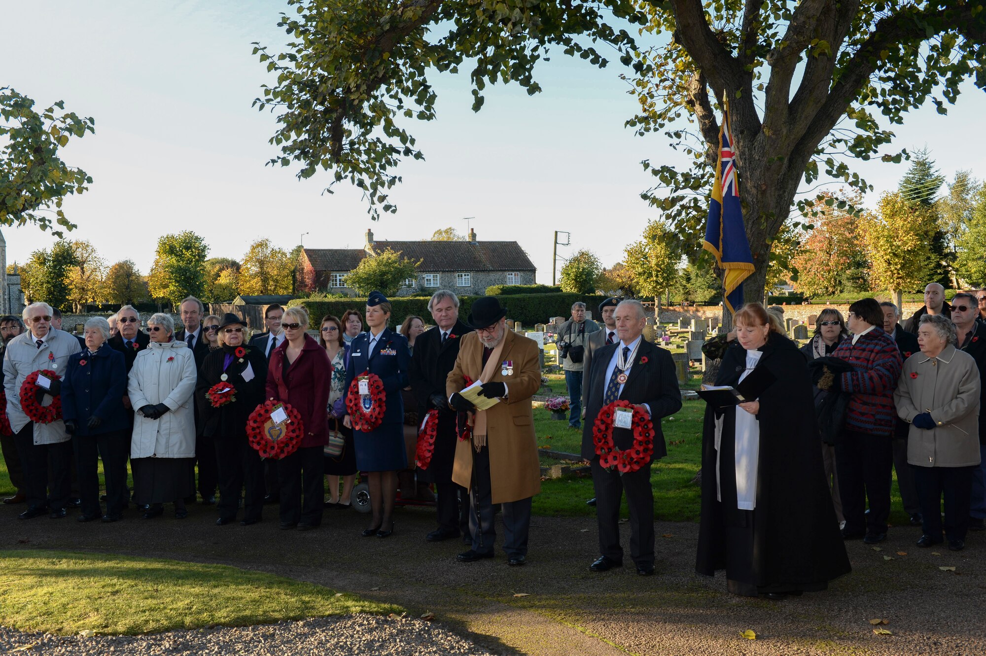 Town council members recite hymns at the Remembrance Day ceremony at the Hillsboro Memorial Gardens in Brandon, England, Nov. 10, 2013. Remembrance Day, also known as Poppy Day, is observed in the commonwealth to honor members of the armed forces who died in the line of duty. (U.S. Air Force photo by Airman 1st Class Nigel Sandridge/Released)