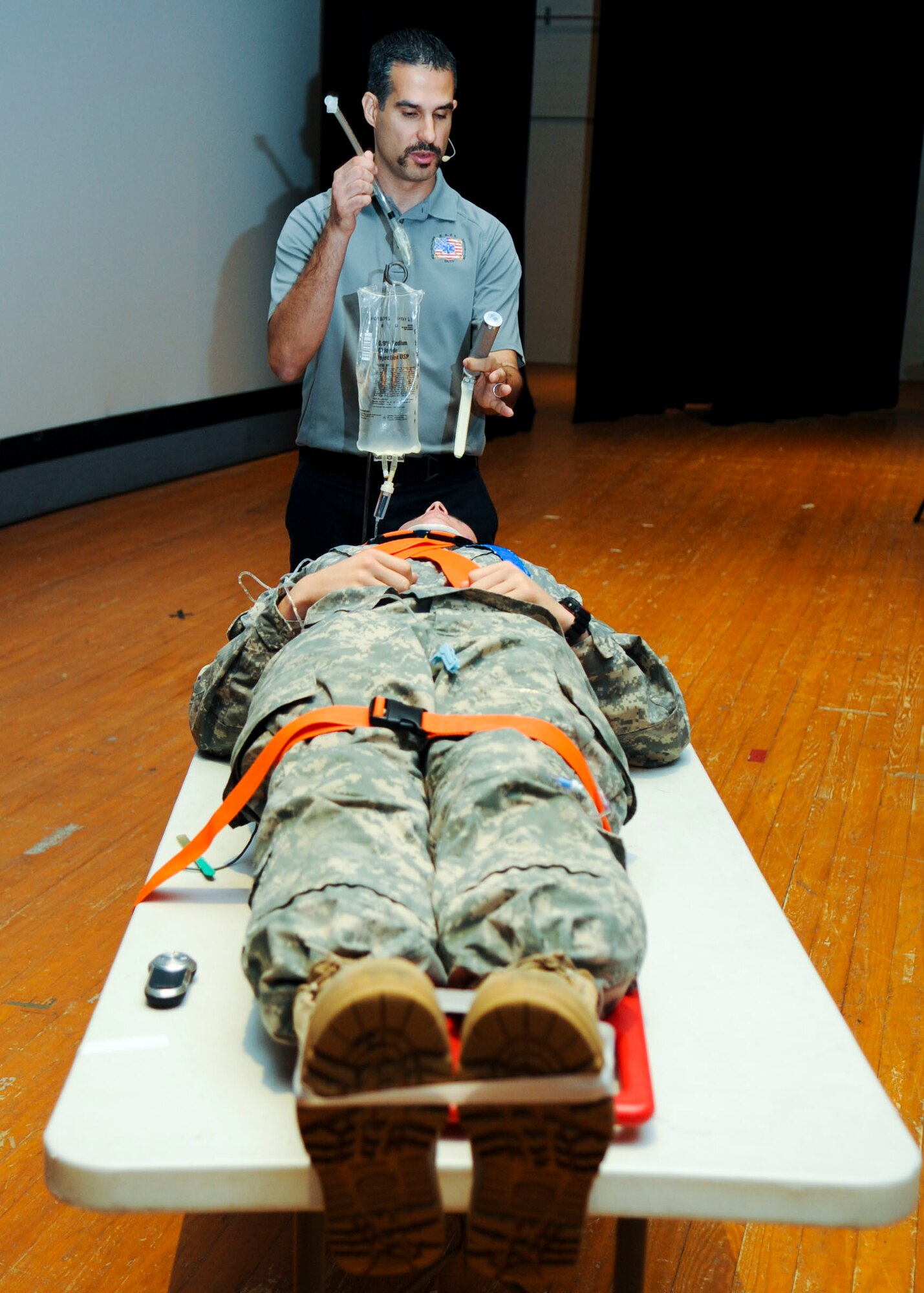 Oscar Duran, Miami-Dade County, Fla., Fire Rescue paramedic, demonstrates a tracheal tube insertion during a Street Smart presentation at Fort Eustis, Va., Nov. 7, 2013. The demonstration showed how paramedics perform life-saving techniques, such as chest tube insertions, and the possible side effects of those techniques, such as paralysis or severe scarring. (U.S. Air Force photo by Airman 1st Class Austin Harvill/Released)
