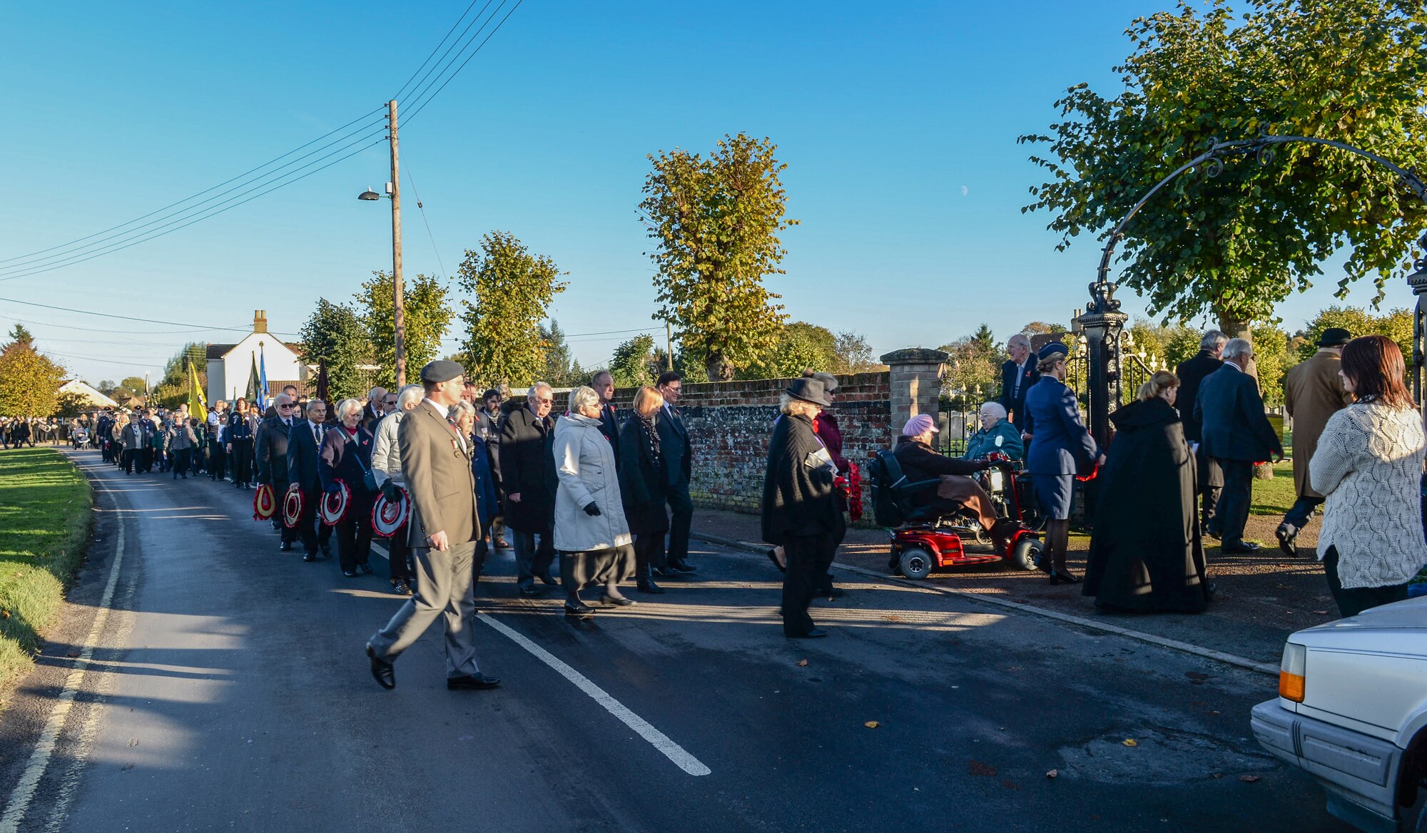 Community members march to the Hillsboro Memorial to participate in the Remembrance Day ceremony in Brandon, England, Nov. 10, 2013. Remembrance Day, also known as Poppy Day, is observed in the commonwealth to honor members of the armed forces who died in the line of duty. (U.S. Air Force photo by Airman 1st Class Nigel Sandridge/Released)