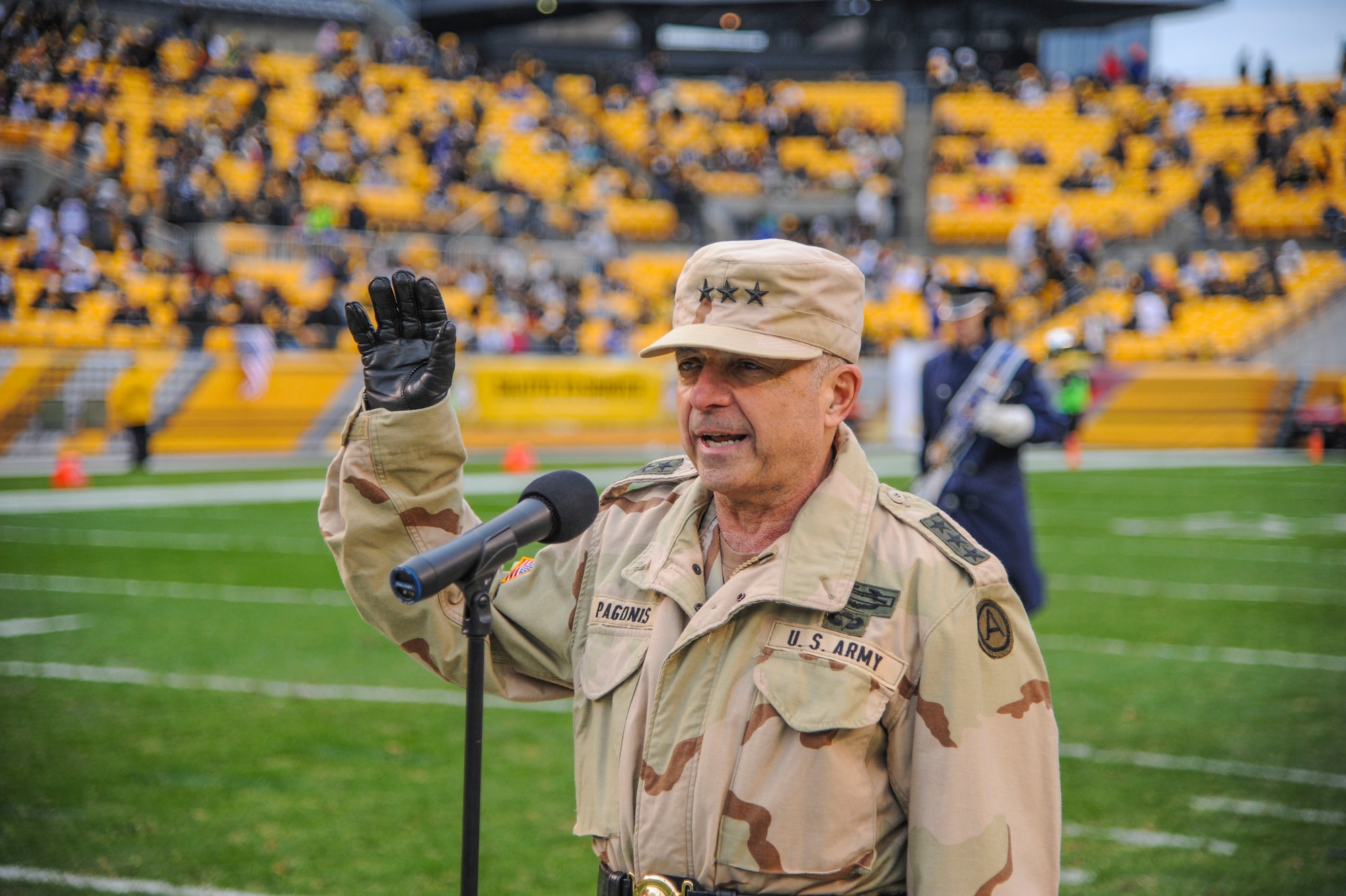 Retired Lt. Gen. William Pagonis conducts a swear-in for 38 recruits from all branches of the military during the Veteran’s Day weekend Salute to Service game in Pittsburgh November 10, 2013. (U.S. Air Force photo by Staff Sgt. Steve Stanley/Released)     