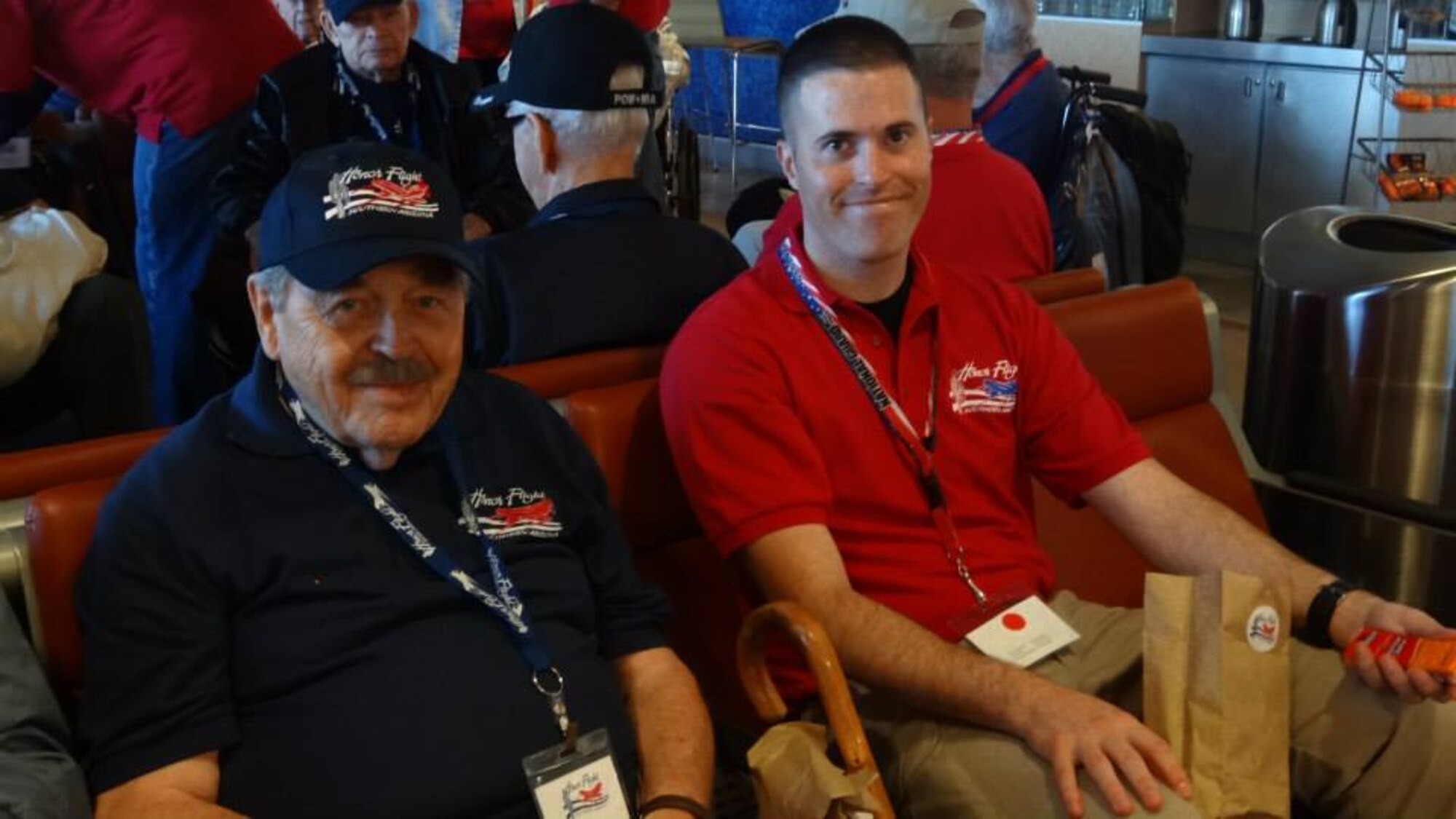 U. S. Air Force Staff Sgt. David Wilcken, 612th Air and Space Operations Center air tasking order production technician, and Robert Yeschek, a World War II, Korean War and Vietnam War veteran, pose at an airport during the Southern Ariz. Honor Flight Trip, Oct. 7, 2013. Wilcken flew with Yeschek during Honor Flight to be his guardian for the duration of the trip. (Courtesy photo) 

