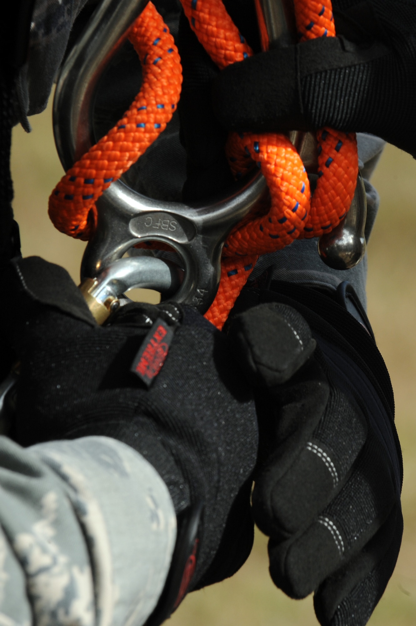 U.S. Air Force Senior Airman Mikel Columbus, 4th Communications Squadron ground radar technician inspects an Airman’s belay device at Seymour Johnson Air Force Base, N.C., Oct. 29, 2013. As part of their training, Airmen were instructed to safely lower themselves, and a person in distress to the ground during a rope rescue. (U.S. Air Force photo by Airman 1st Class Aaron J. Jenne)