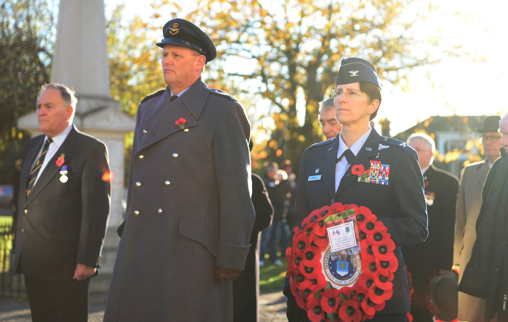 Sqn. Ldr. Jerry Neild, Royal Air Force commander, RAF Lakenheath and Col. Margaret Walsh, 48th Inpatient Operations Squadron commander, stand in formation in front of the memorial site in Lakenheath, England, for Remembrance Day, Nov. 10, 2013. The commonwealth observes Remembrance Day to honor the memories of men and women of the armed forces that have lost their lives in wars, past and present. (U.S. Air Force photo by Airman 1st Class Dawn M. Weber/Released) 