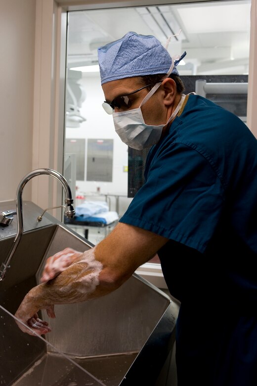 U.S. Air Force Dr. (Maj.) Arthur Greenwood, 633rd Medical Operation Squadron staff obstetrician-gynecologist, washes his hands prior to surgery at Langley Air Force Base, Va., Nov. 8, 2013. Greenwood works in the Women’s Health clinic and specializes in single-incision laparoscopic hysterectomies. (U.S. Air Force photo by Staff Sgt. Stephanie R. Plichta/Released)
