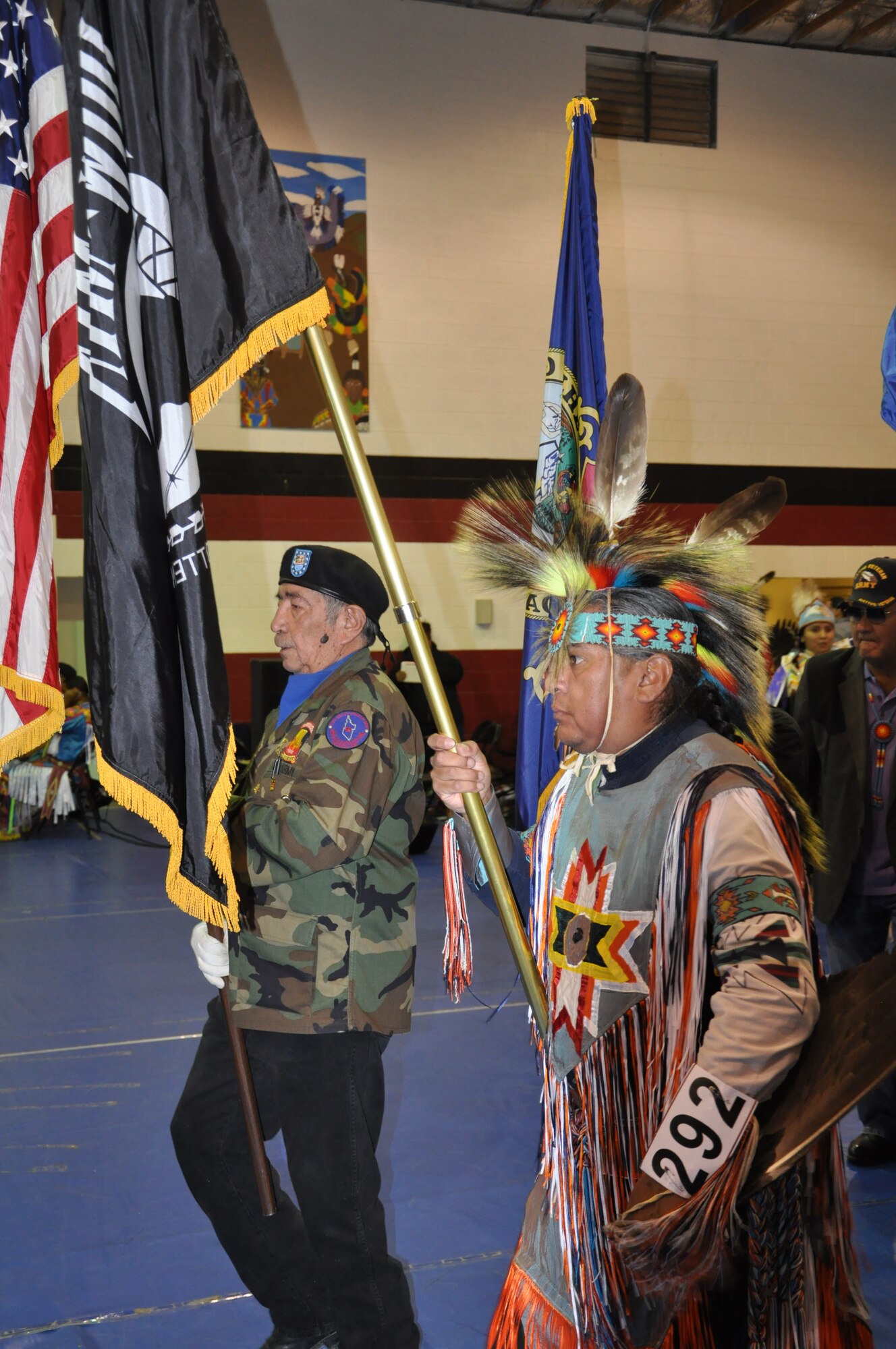 Veterans from the Shoshone Paiute tribe carry the American and POW flags during the grand entry of the tribe’s Veterans Day Pow Wow, Nov. 9, 2013. U.S. Air Force Col. Christopher Short, 366th Fighter Wing commander, and other Airmen from Mountain Home Air Force Base joined the tribe honoring veterans of all services.(U.S. Air Force photo by 1st Lt. Phillip Davis/RELEASED)