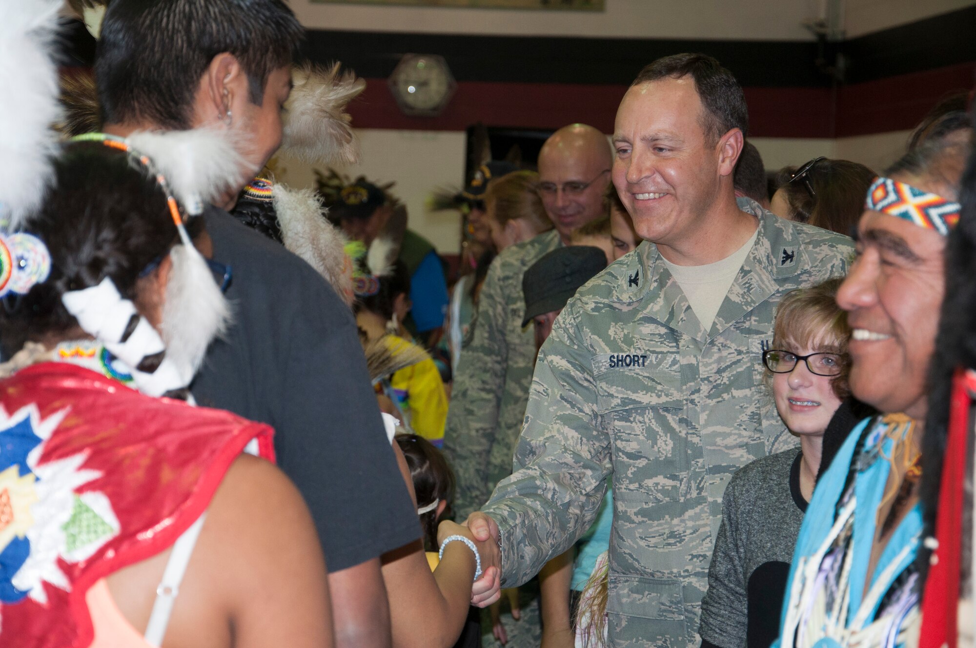 U.S. Air Force Col. Christopher Short, 366th Fighter Wing commander, shakes hands with members of the Shoshone Paiute tribe during a Veterans Day Pow Wow, Nov. 9, 2013. The Pow Wow honored veterans of all services and allowed tribal members to an opportunity to say thank you. (U.S. Air Force photo by 1st Lt. Phillip Davis/RELEASED)