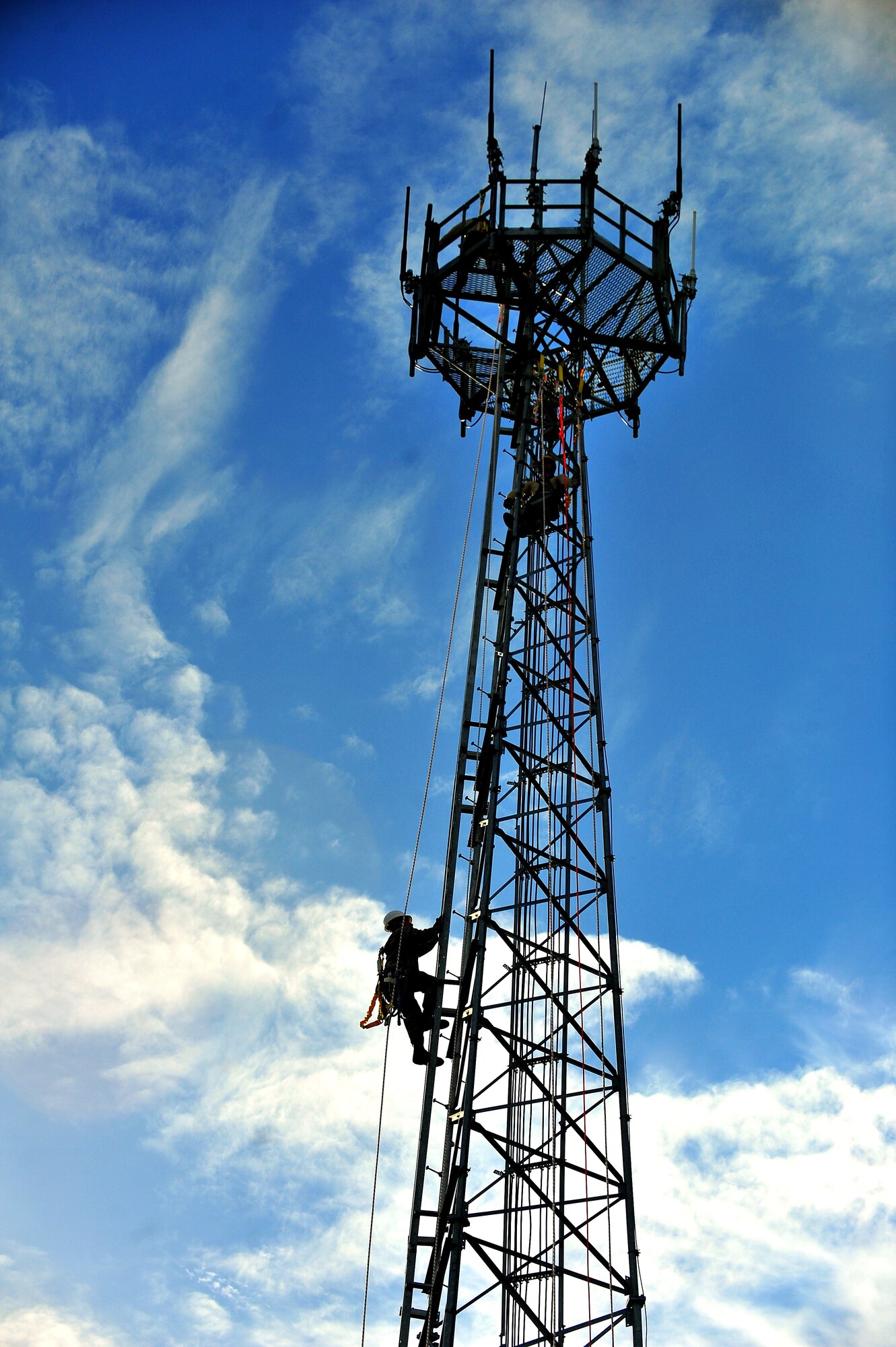 A 4th Communications Squadron airfield systems technician climbs a 100-foot tower during a training exercise at Seymour Johnson Air Force Base, N.C., Oct. 29, 2013. During the exercise, Airmen focused on inspecting safety gear, tying knots and properly maintaining electronics housed on the tower. (U.S. Air Force photo by Senior Airman Aubrey White)