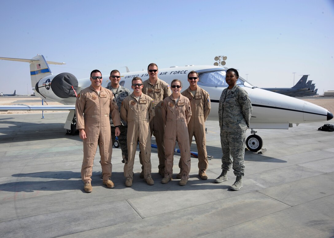 Airmen assigned to the 379th Air Expeditionary Group C-21 Firebass unit pose for a photo at the 379th Air Expeditionary Wing in Southwest Asia, Nov. 5, 2013. The C-21’s primary mission here is distinguished visitor transport throughout the U.S. Air Forces Central Command area of responsibility. The members are deployed from Joint Base Andrews, Md., and Scott Air Force Base, Ill. (U.S. Air Force photo/Senior Airman Bahja J. Jones) 