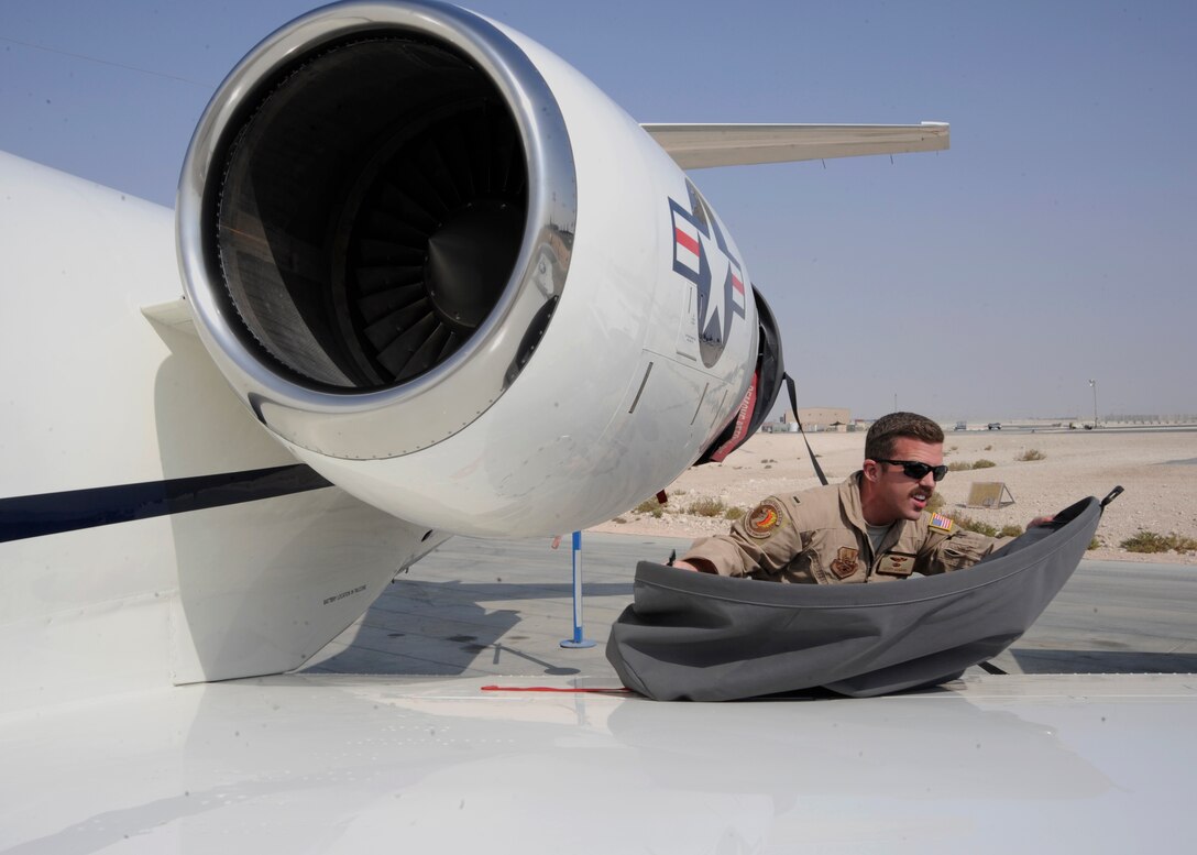 1st Lt. Geoff Howard removes a dust cover from the engine of a C-21 Firebass at the 379th Air Expeditionary Wing in Southwest Asia, Nov. 5, 2013. Distinguished visitor transport is a key resource in a deployed location as it enables decision makers to have face-to-face contact while building partnerships. Howard is a 379th Expeditionary Operation Group C-21 pilot deployed from Joint Base Andrews, Md., and hails from San Antonio, Texas. (U.S. Air Force photo/Senior Airman Bahja J. Jones) 