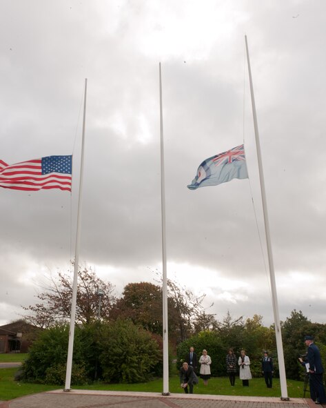 RAF ALCONBURY, United Kingdom – Chris Lewney spreads his grandfather’s ashes at the RAF Alconbury flagpoles Oct. 26. Retired Tech. Sgt. Emil Dihlmann served at RAF Alconbury from 1943 to 1945 and he had such fond memories of his time there that his family asked if they could spread his ashes on the base. (U.S. Air Force photo by Staff Sgt. Brian Stives)