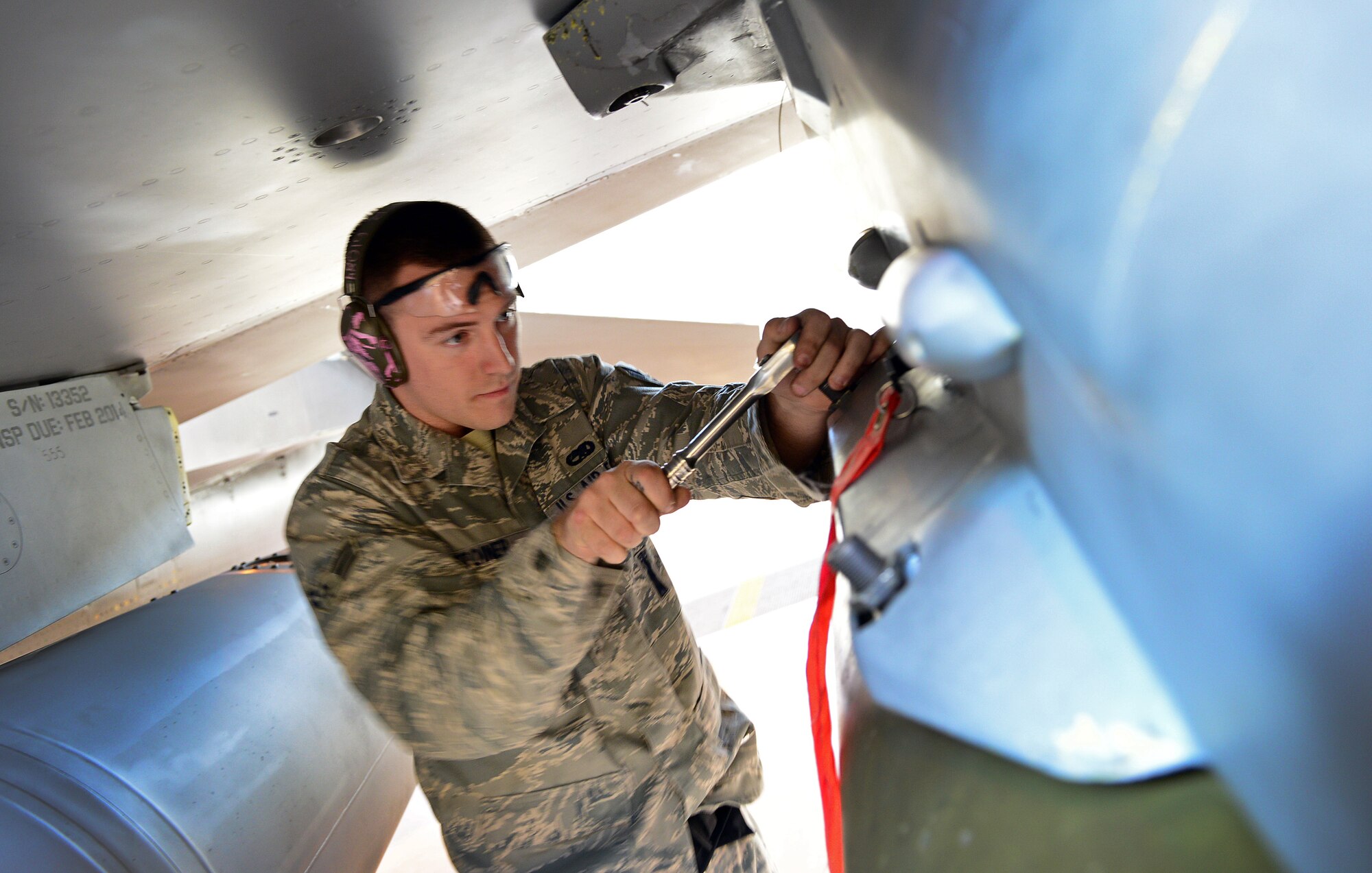 Airman 1st Class Randall Stoiner, 31st Aircraft Maintenance Squadron weapons load crew member, tightens a bolt, Nov. 6, 2013, at Aviano Air Base, Italy. Known as “flightline loaders,” these Airmen work hand-in-hand with the armament shop to help perform yearly function checks on Aviano’s F-16 equipment. (U.S Air Force photo/Senior Airman Matthew Lotz)