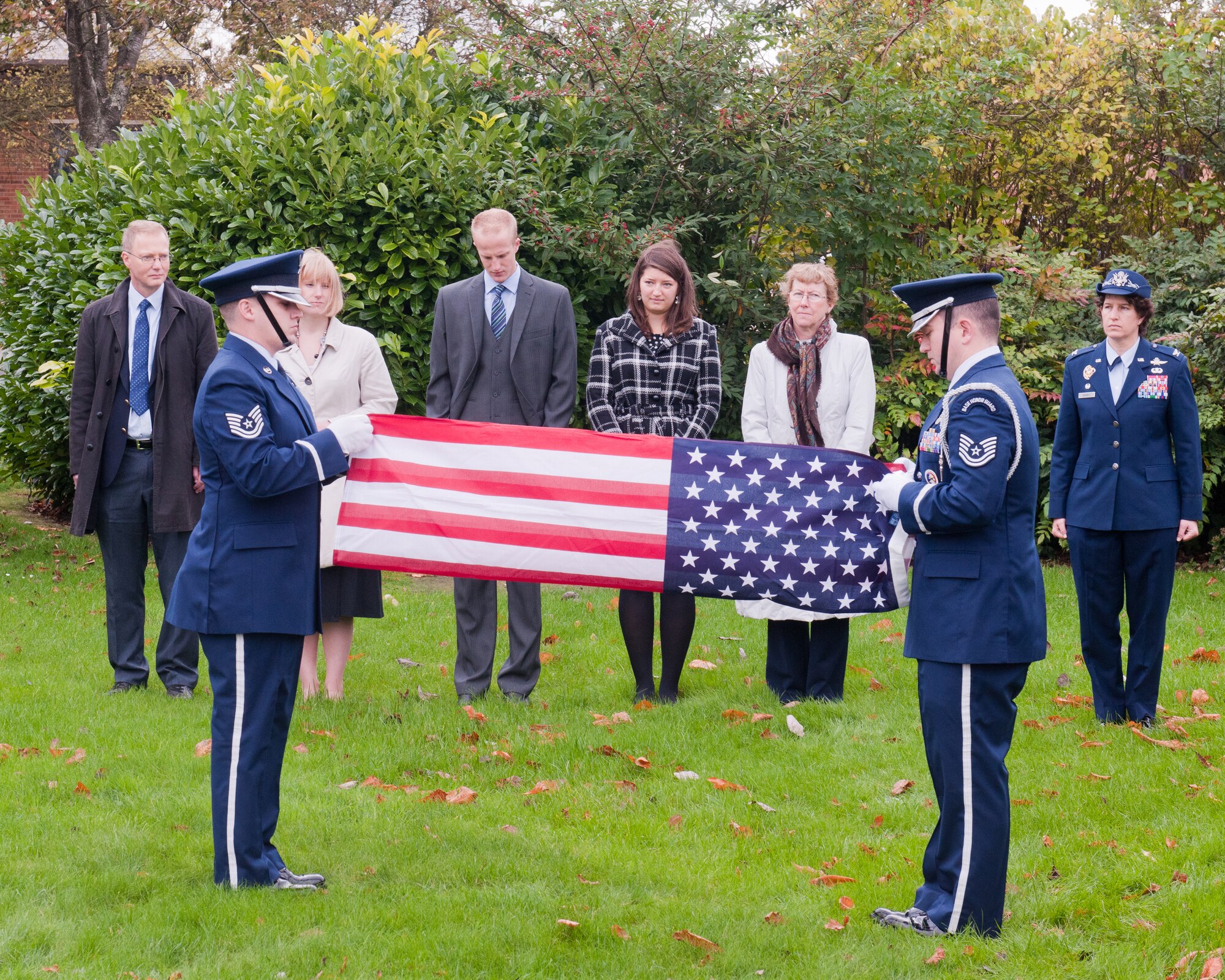 RAF ALCONBURY, United Kingdom – Tech. Sgts. Jeffrey Empson and Christopher Ackerman, 423rd Air Base Group Honor Guard, fold the U.S. flag during a ceremony for retired Tech. Sgt. Emil Dihlmann at the RAF Alconbury flagpoles Oct. 26. Dihlmann served at RAF Alconbury from 1943 to 1945 and he had such fond memories of his time there that his family asked if they could spread his ashes on the base. (U.S. Air Force photo by Staff Sgt. Brian Stives)