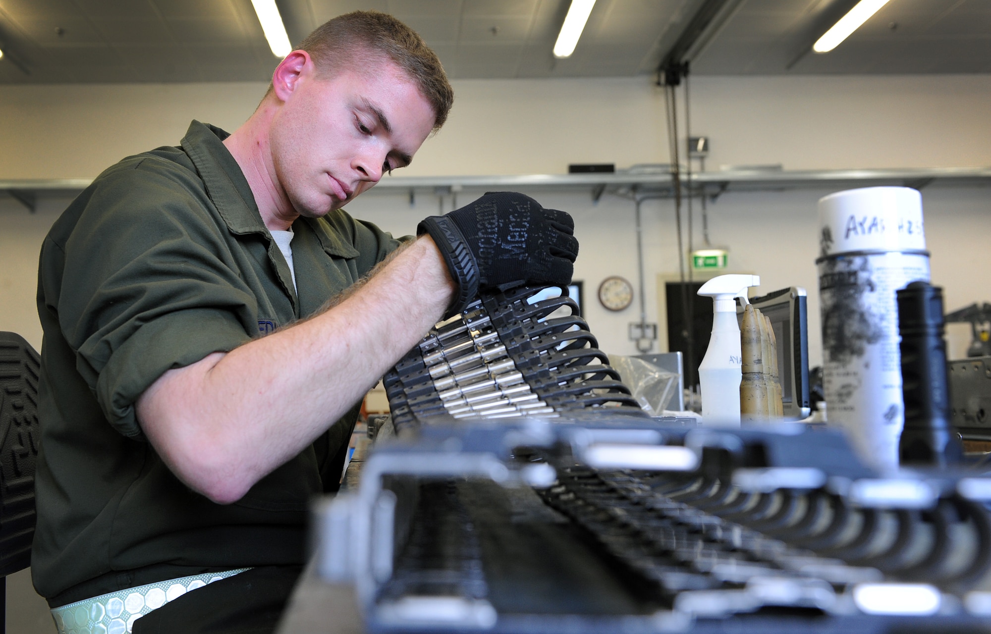 Senior Airman Sean Edmondson, 31st Munitions Squadron armament technician, inspects chutes for a gun system, Nov. 5, 2013, at Aviano Air Base, Italy. The armament section is in charge of performing yearly function checks on aircraft equipment. (U.S. Air Force photo/Senior Airman Matthew Lotz)