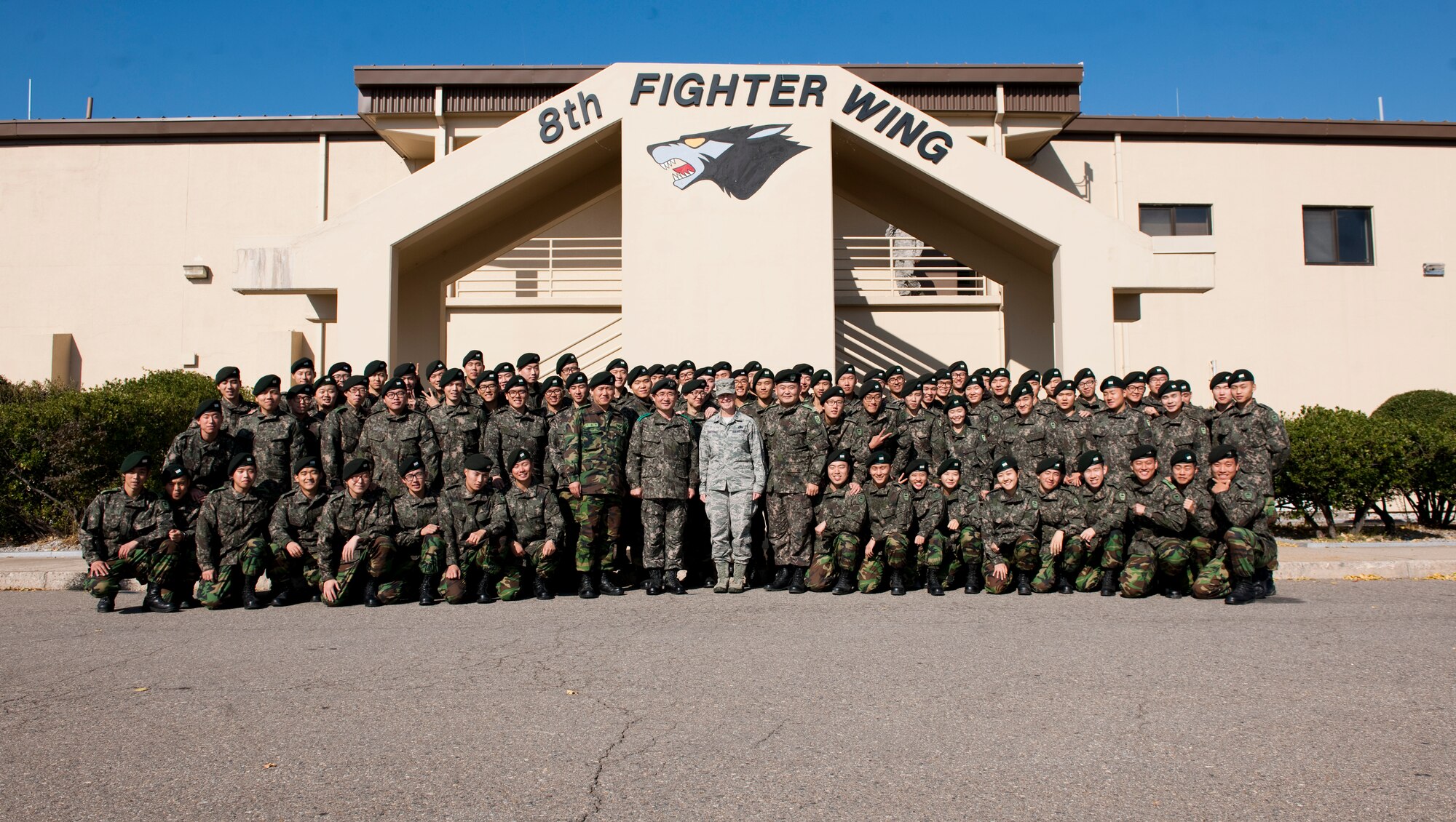 Republic of Korea cadets pose with Col. Carrie Bausano, 8th Mission Support Group commander,  leadership at Kunsan Air Base, Republic of Korea, Nov. 13, 2013. Approximately 80 Republic of Korea cadets visited the Wolf Pack to view the joint mission with a tour of the air traffic control tower and mission brief. (U.S. Air Force photo by Senior Airman Armando A. Schwier-Morales/Released)