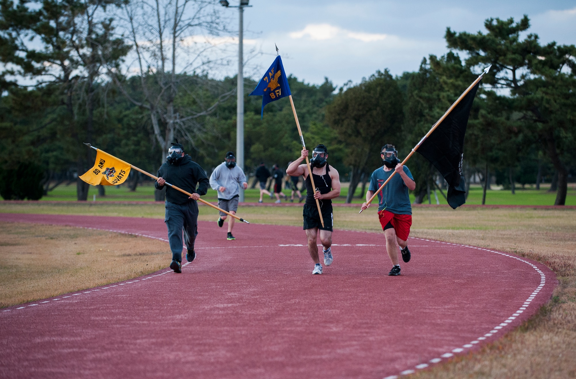 Members of the 80th Aircraft Maintenance Unit take part in the Veterans Day Vigil at Kunsan Air Base, Republic of Korea, Nov. 11, 2013. The Wolf Pack observed the sacrifices of all veterans during a 12-hour vigil at the fitness center track. (U.S. Air Force photo by Senior Airman Clayton Lenhardt/Released)